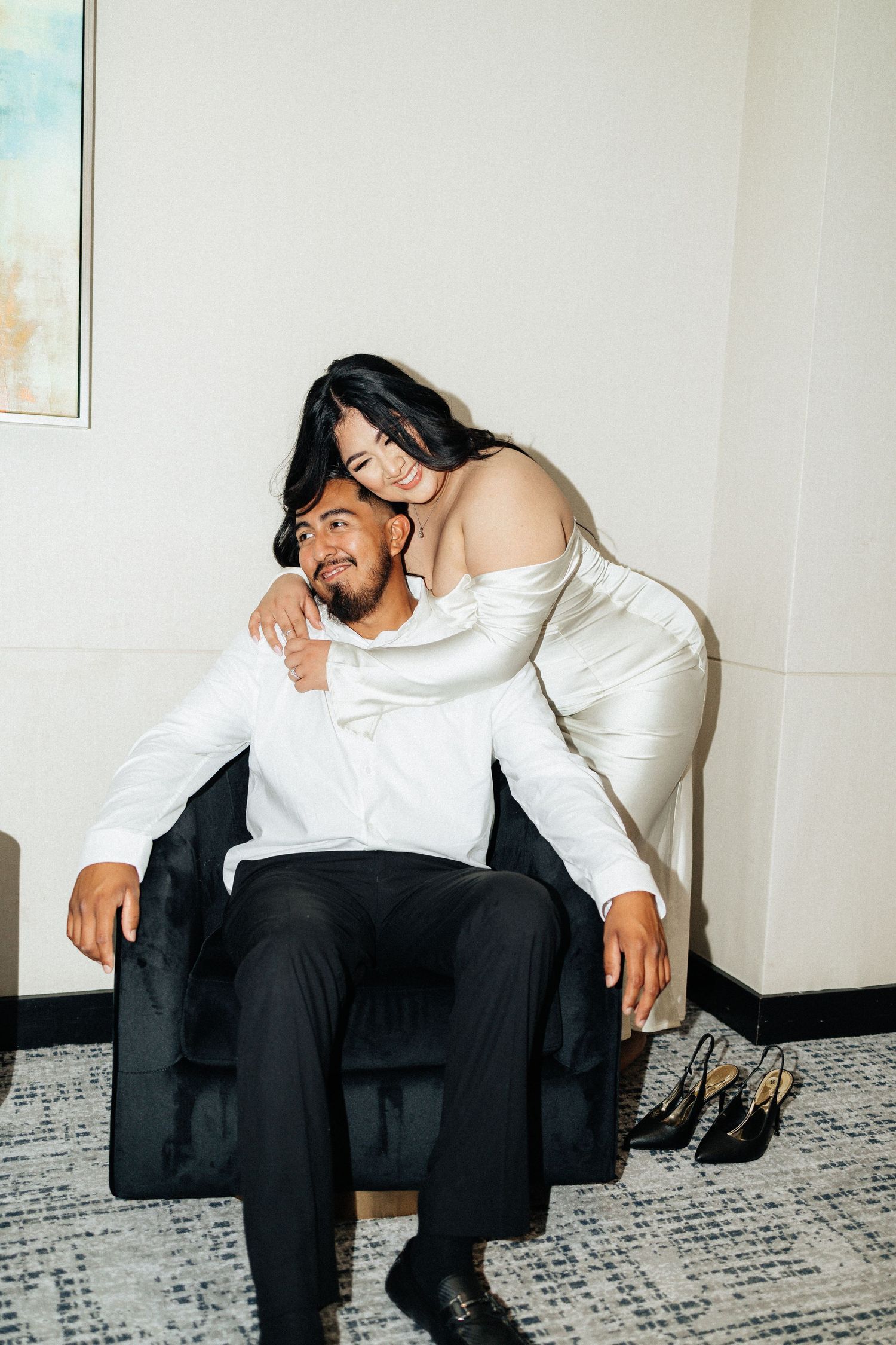 Engagement session downtown oklahoma city. Bride is wearing a white dress. flash photography in a hotel hallway.