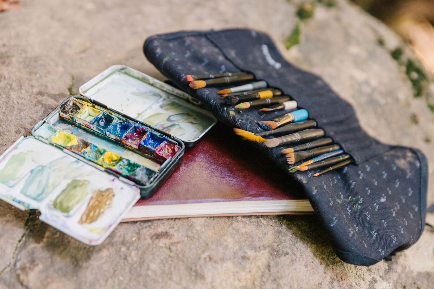 Close-up images showing the transition of a worn leather wallet being unfolded and displayed on a concrete surface.