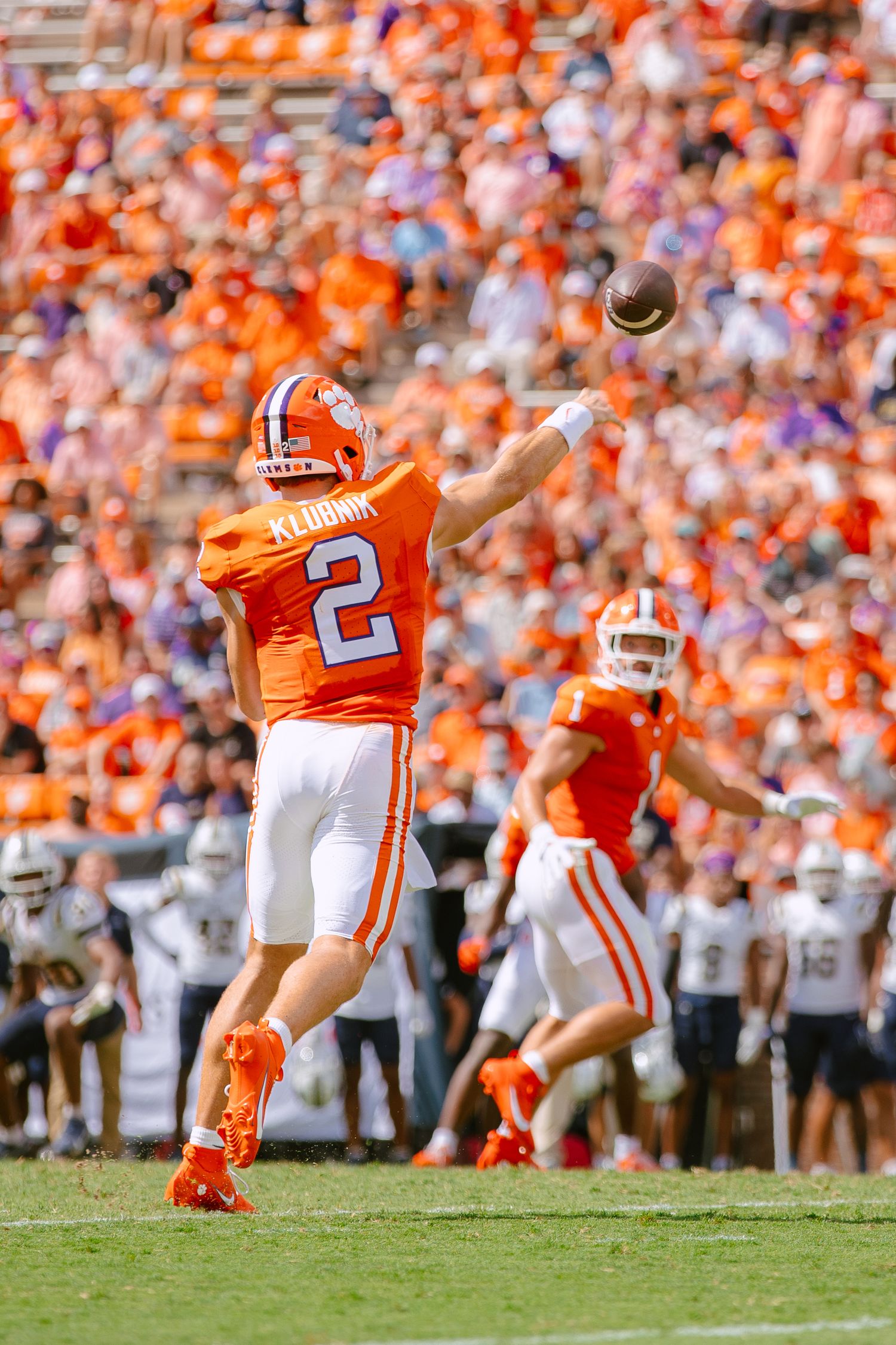 Sequence of a football kicker performing a field goal attempt in orange jersey against white uniformed opponents.