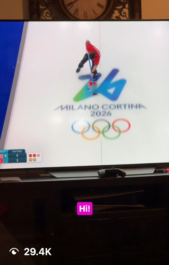 A TV screen displaying the Milano Cortina 2026 Winter Olympics logo with an athlete performing on ice.