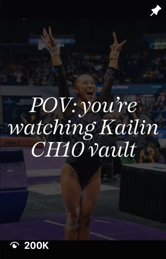 Gymnast Kailin celebrates after completing a vault routine, arms raised in victory, at a competitive gymnastics event.
