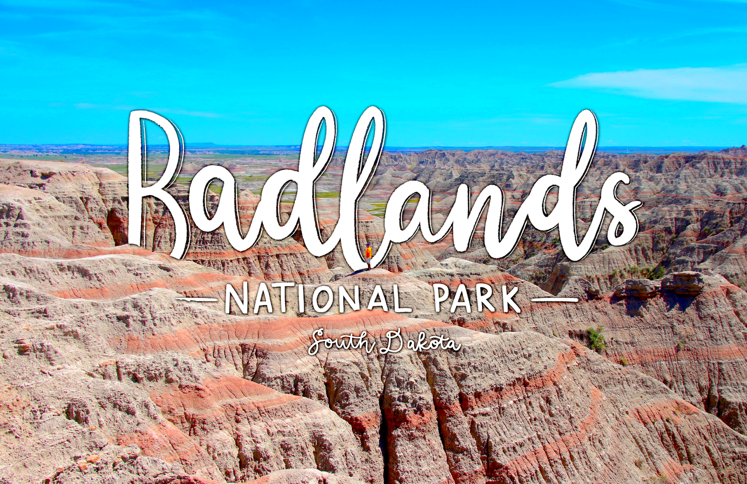 Scenic view of eroded rock formations at Badlands National Park with white text overlay against bright blue sky.