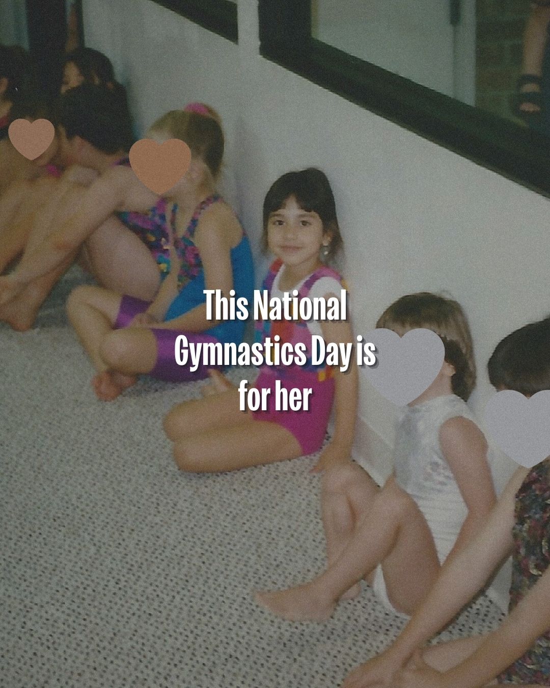Young gymnasts practicing flexibility exercises on a carpeted floor during training.