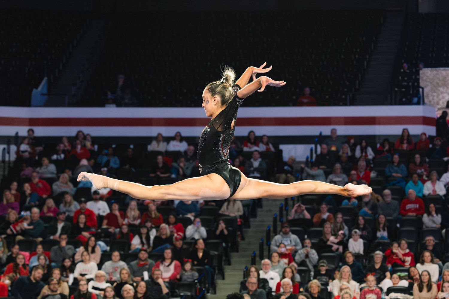 A dramatic series of athletic gymnastics moves showing a floor routine sequence with graceful leaps and turns.