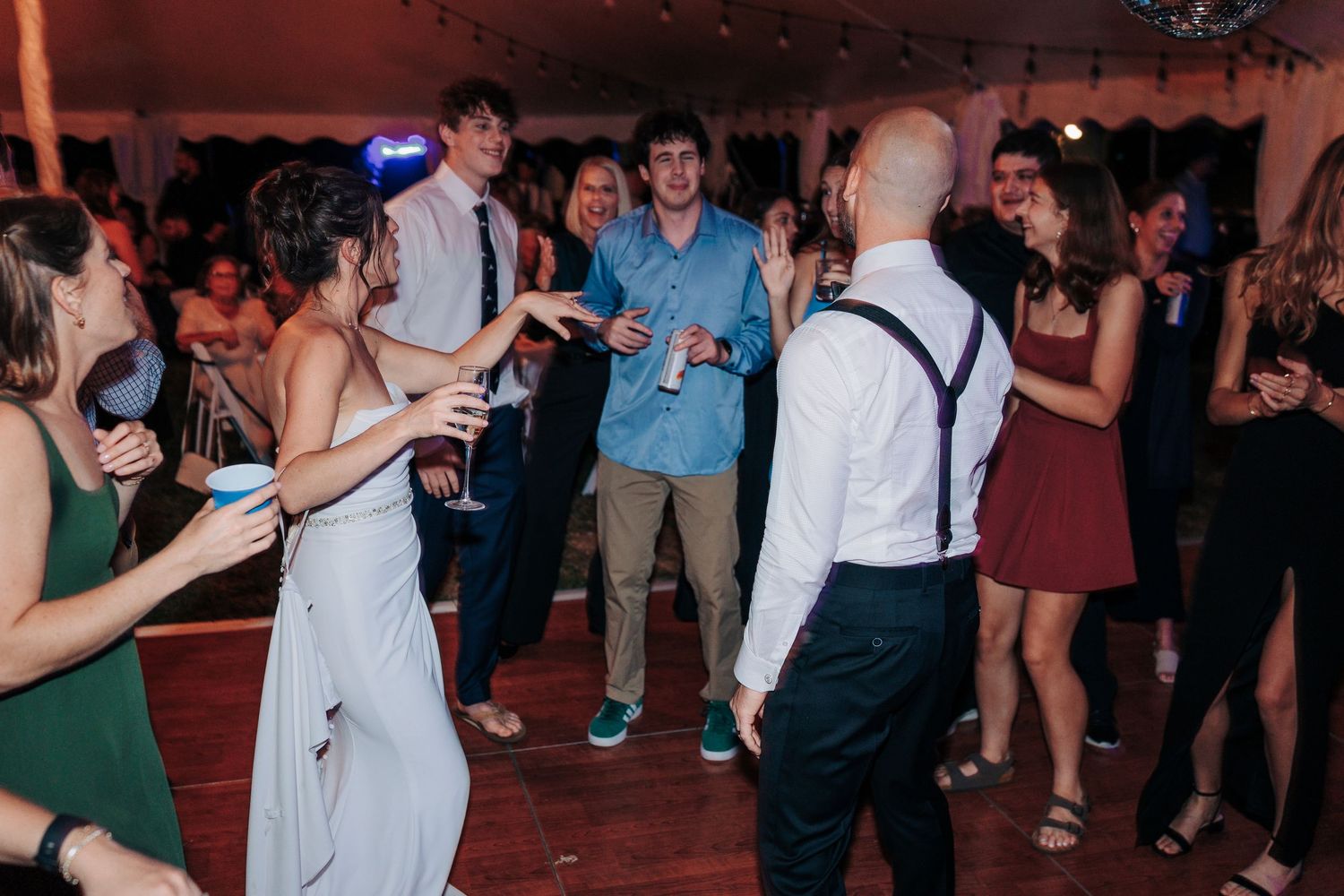 Lively dance floor moments captured during an indoor wedding reception celebration.