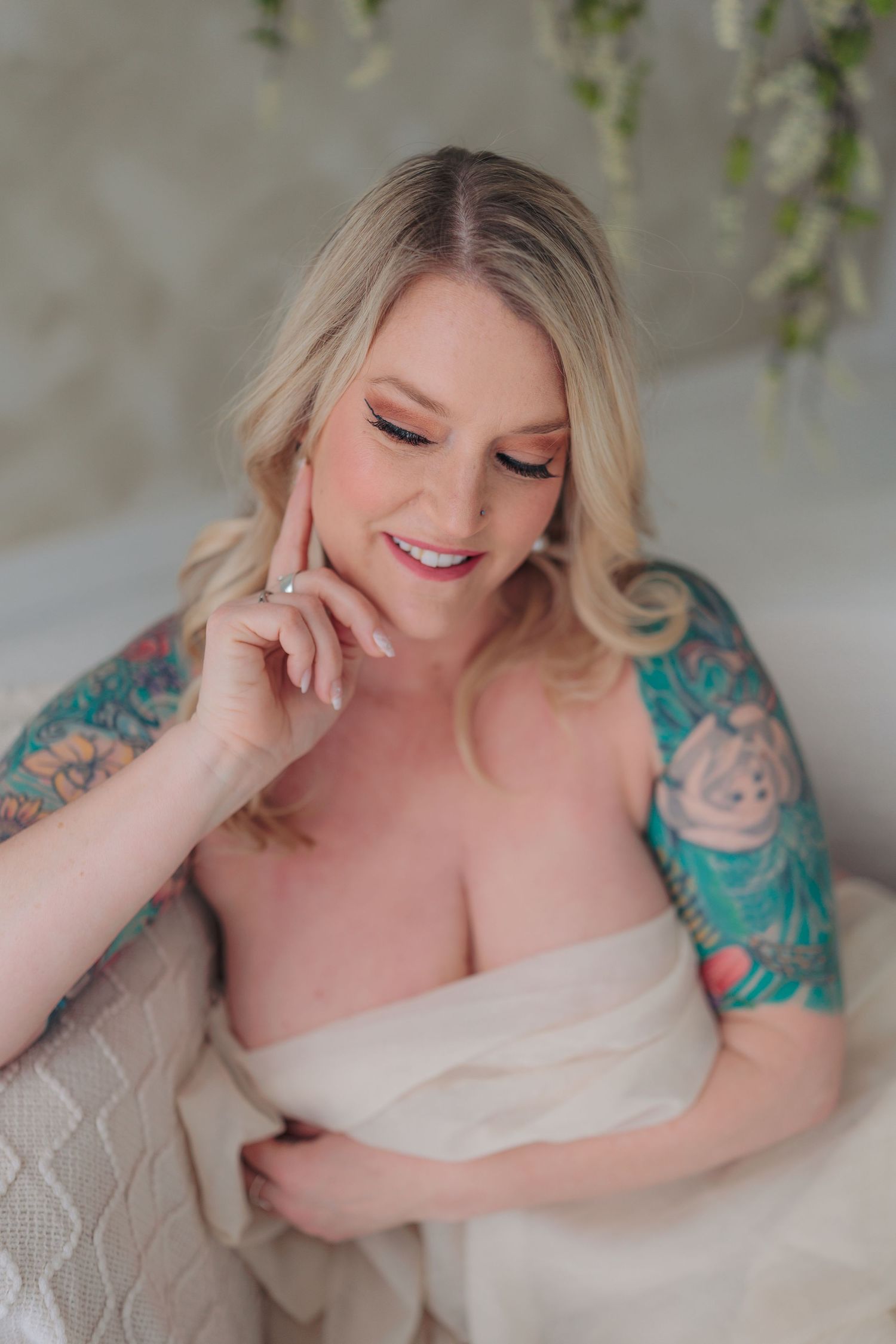 Dreamy boudoir photography series showing soft poses against light floral backdrop in romantic setting.