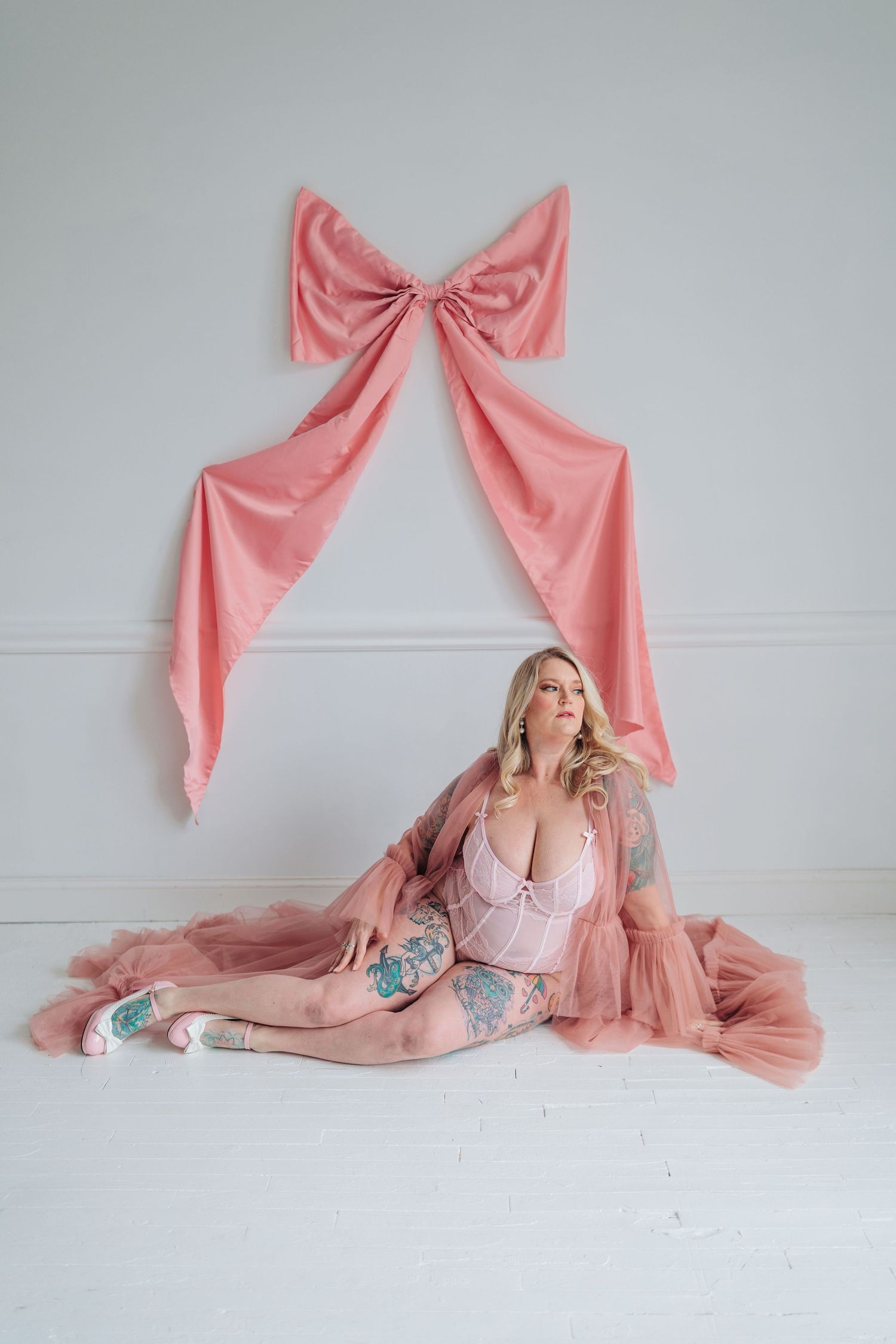 A series of pink bow-themed artistic photos featuring soft pastel decor and feminine styling against a white wall.
