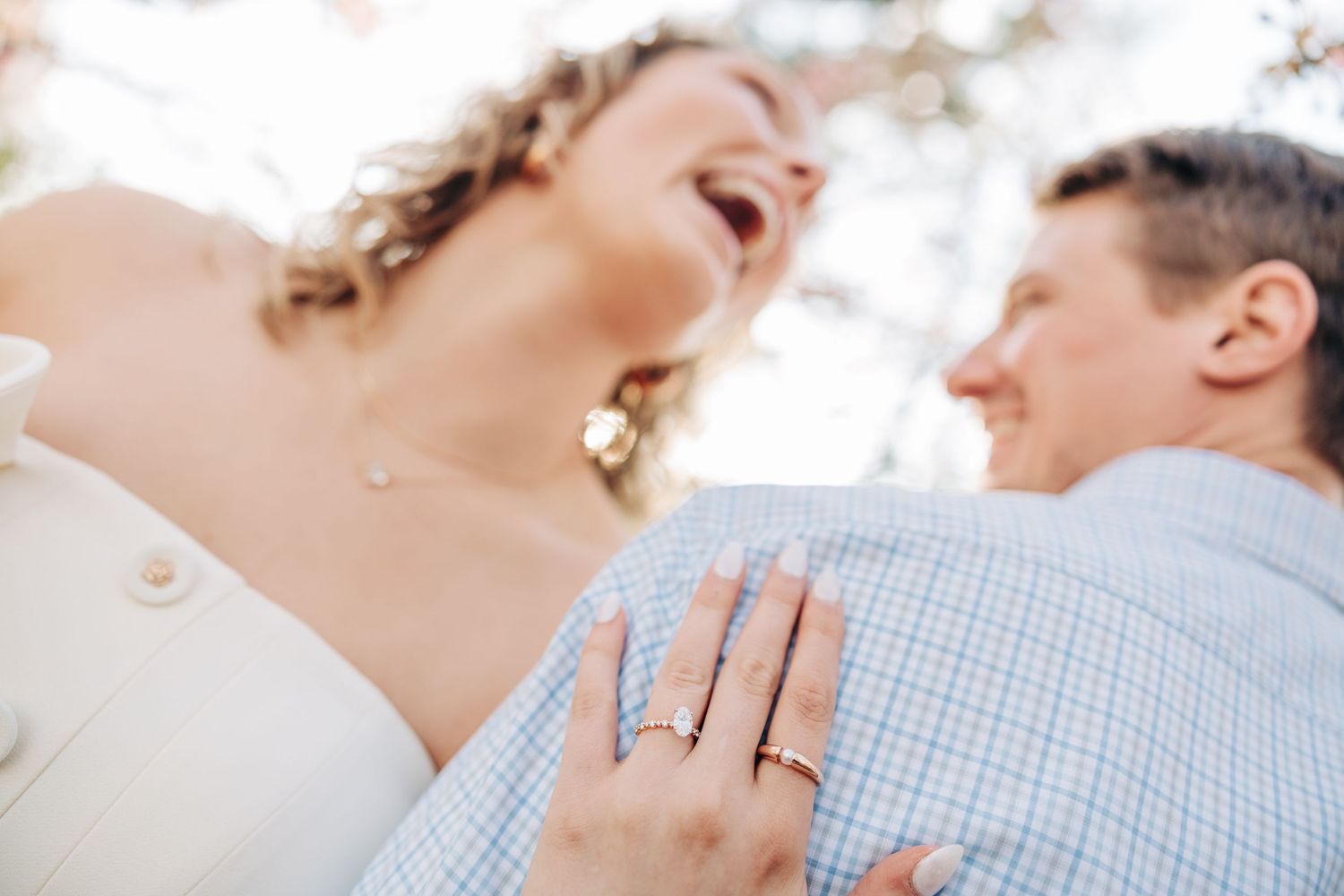 A joyful close-up moment showing an engagement ring during a proposal.