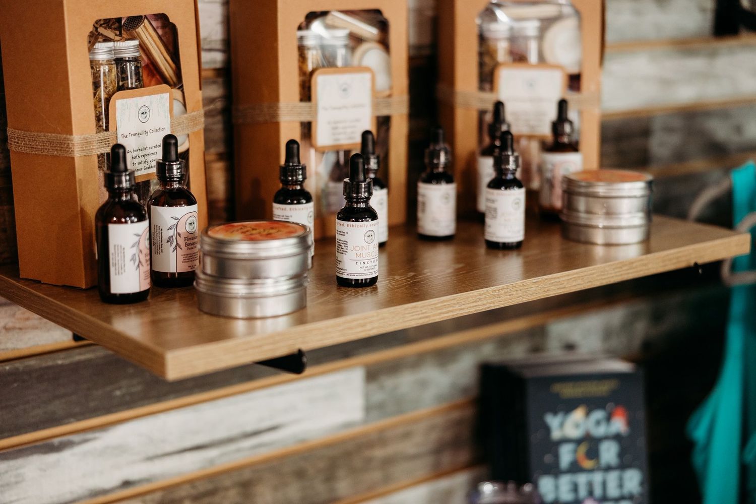 Wooden shelf displaying various bottles and containers in warm lighting.