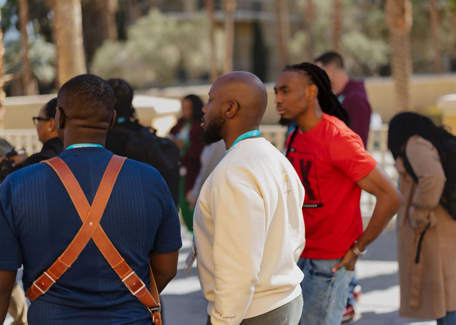 Small group of people gathered outdoors wearing casual clothing.