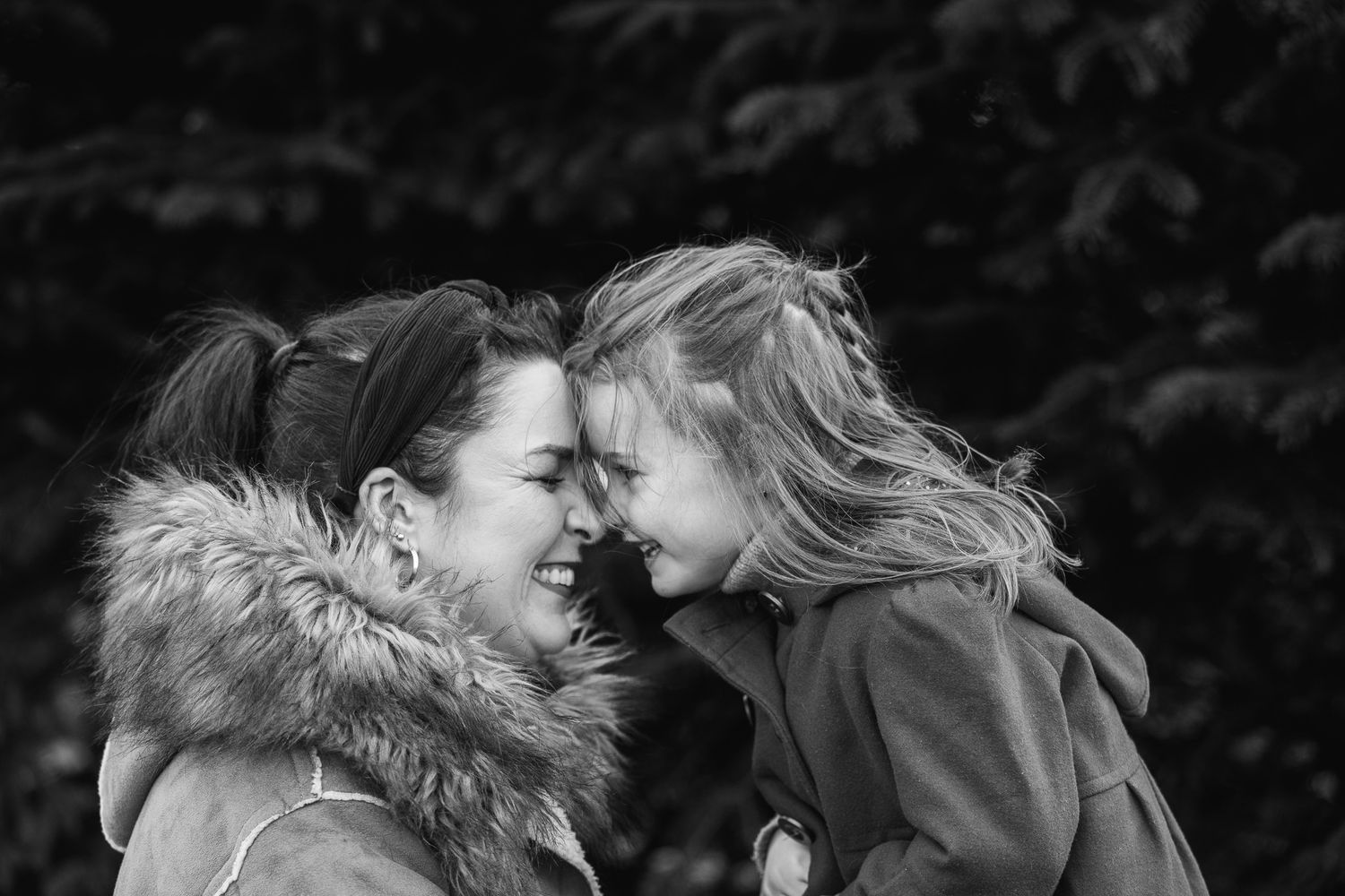 Close-up professional portrait shots against a black background showing joy and laughter.
