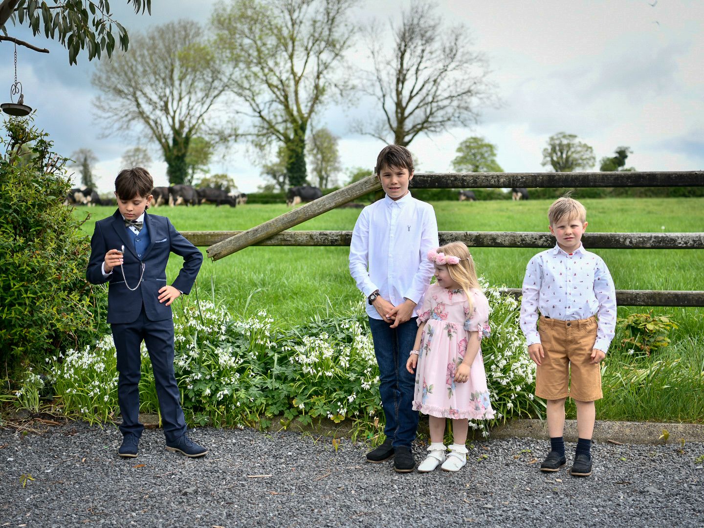 Group photo session in a lush green countryside setting.