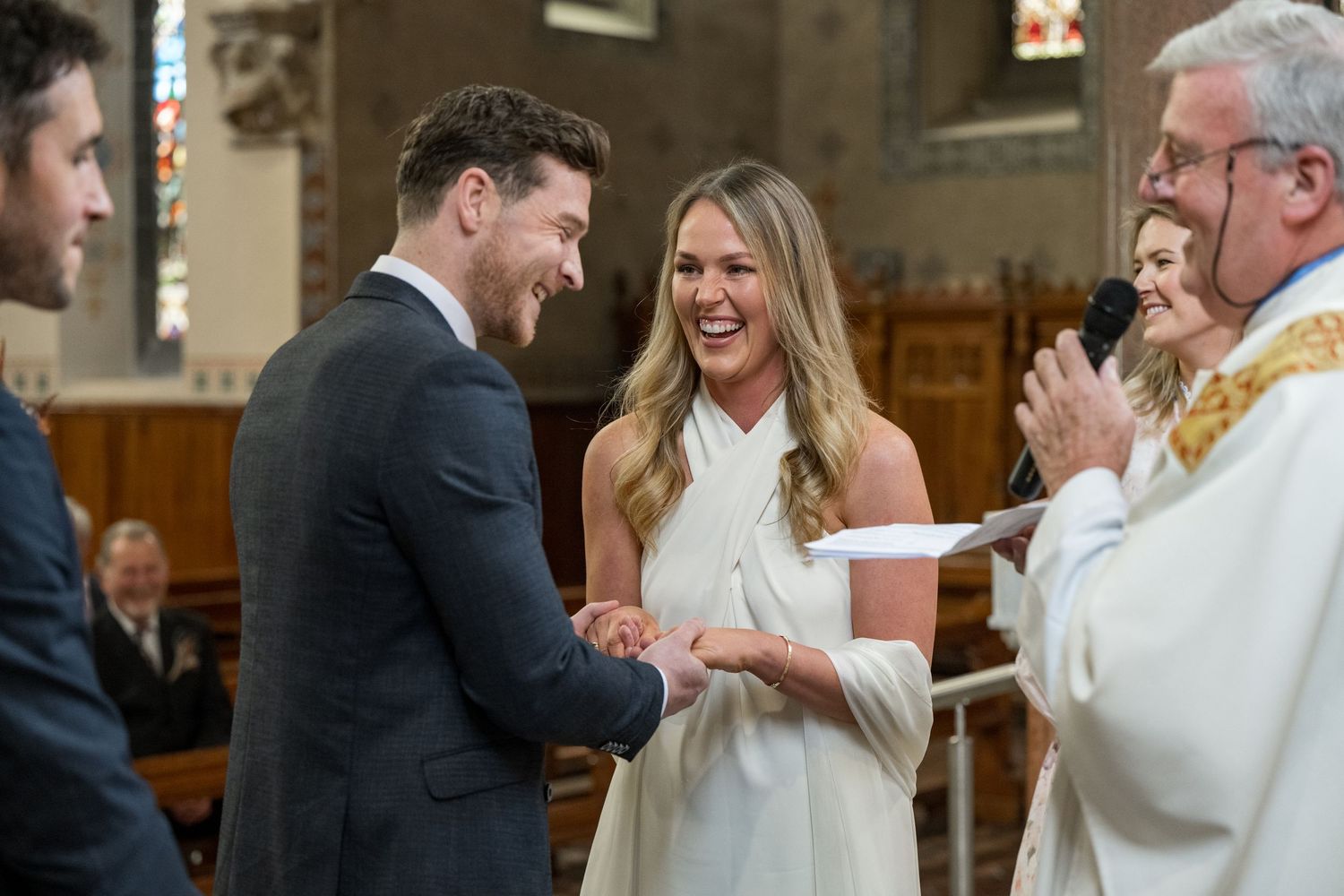 A joyful wedding ceremony moment captured inside a traditional church.
