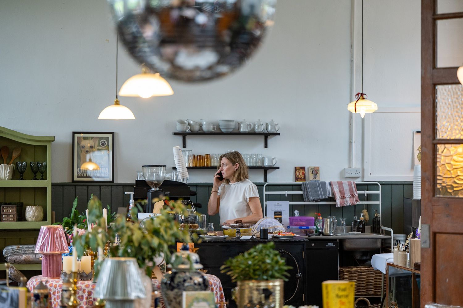 Rustic cafe interior with vintage lighting fixtures and wooden furniture.