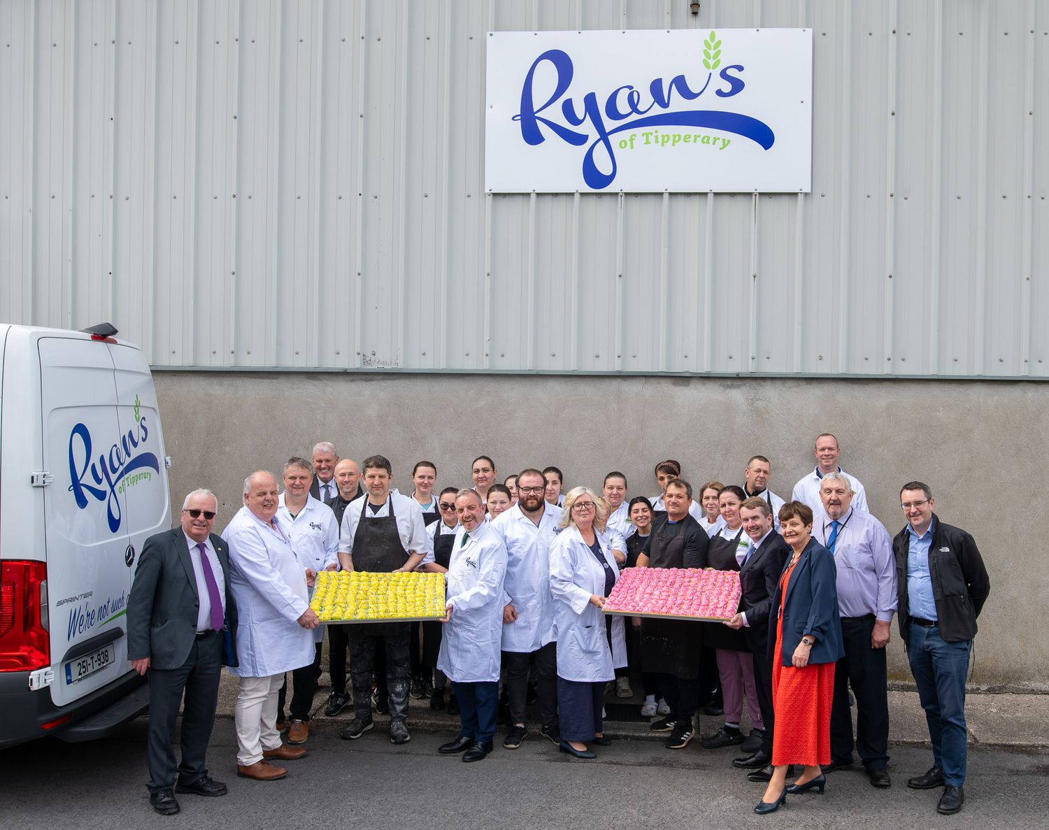 Staff members gather for a group photo outside Ryan's food facility.