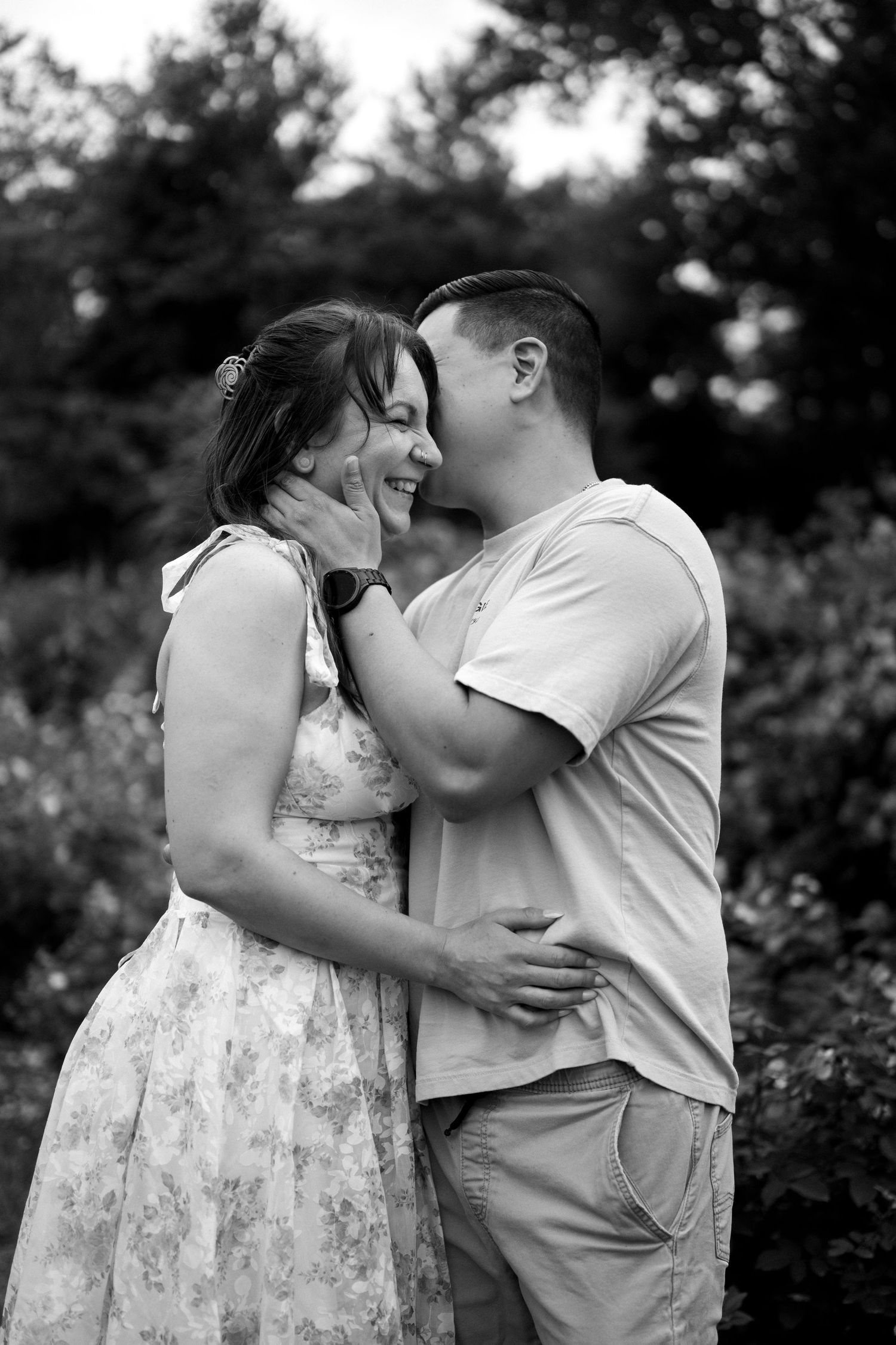 An intimate moment between a couple embracing in a garden setting, captured in black and white. Northern Virginia Family Photographer