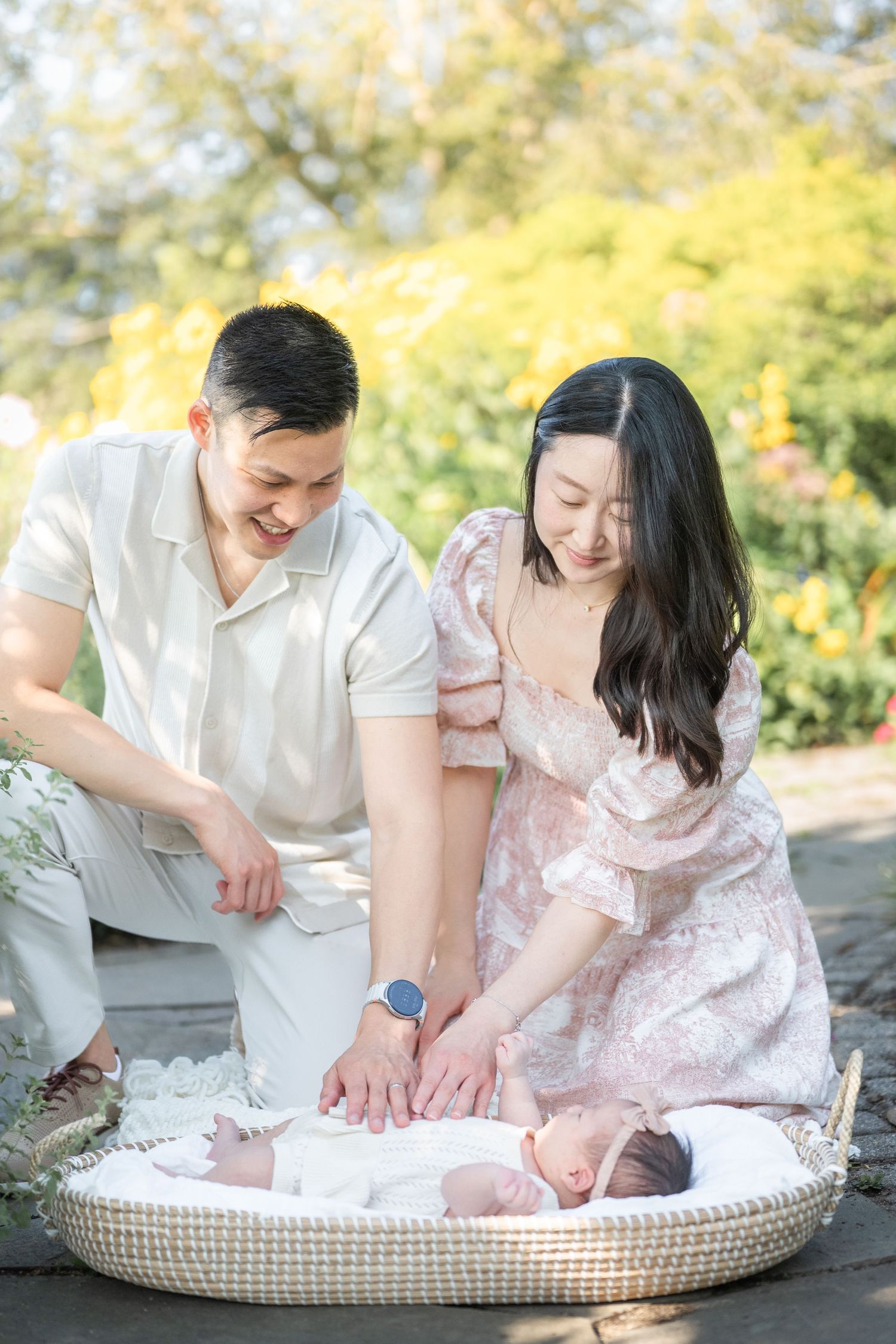 A series of tender lifestyle photos showing parents with their newborn baby on a cozy cushion in an outdoor setting. Arlington photographer
