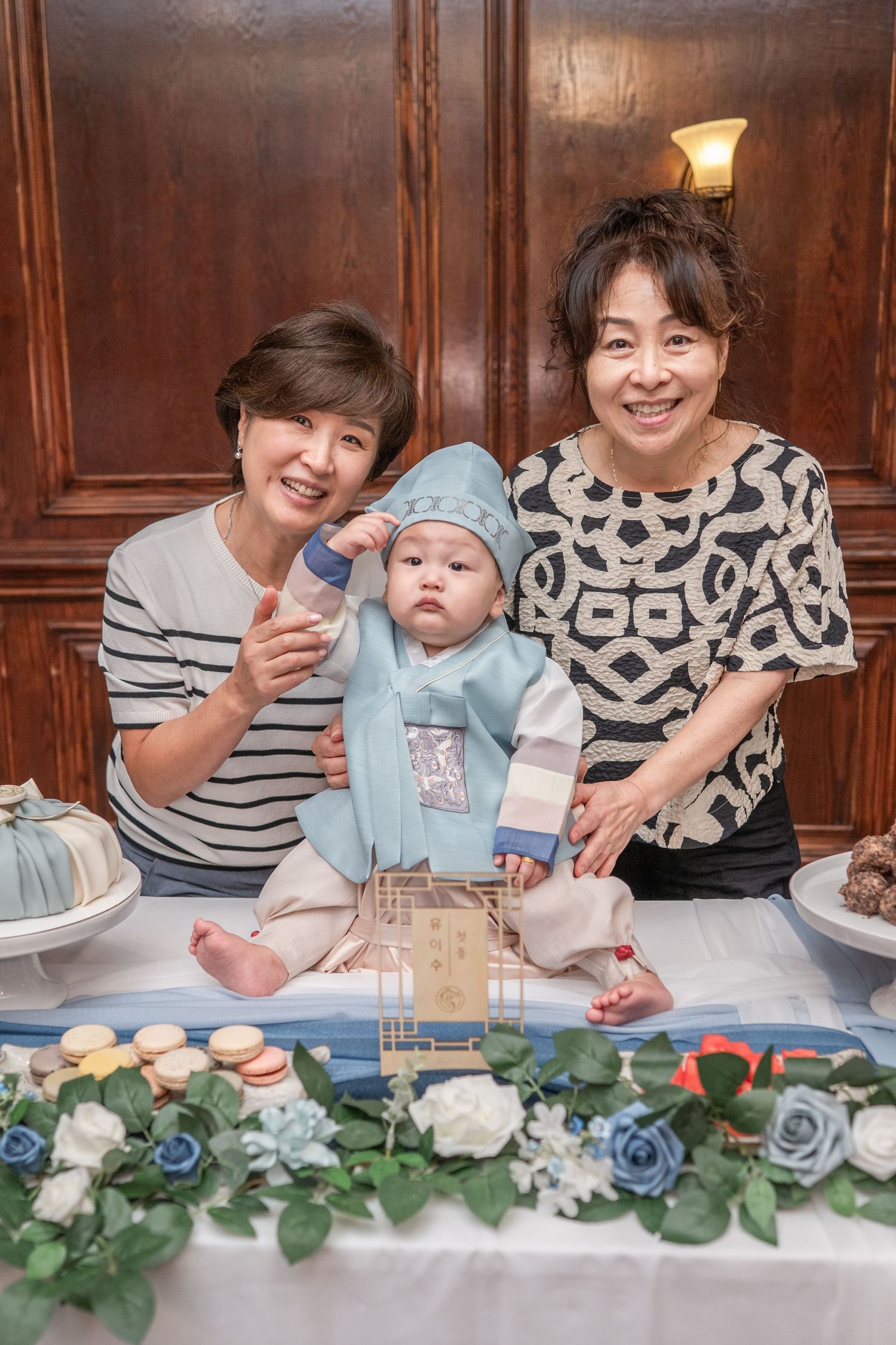 A series of candid photos showing people enjoying cake and refreshments at a celebration with blue floral decorations.