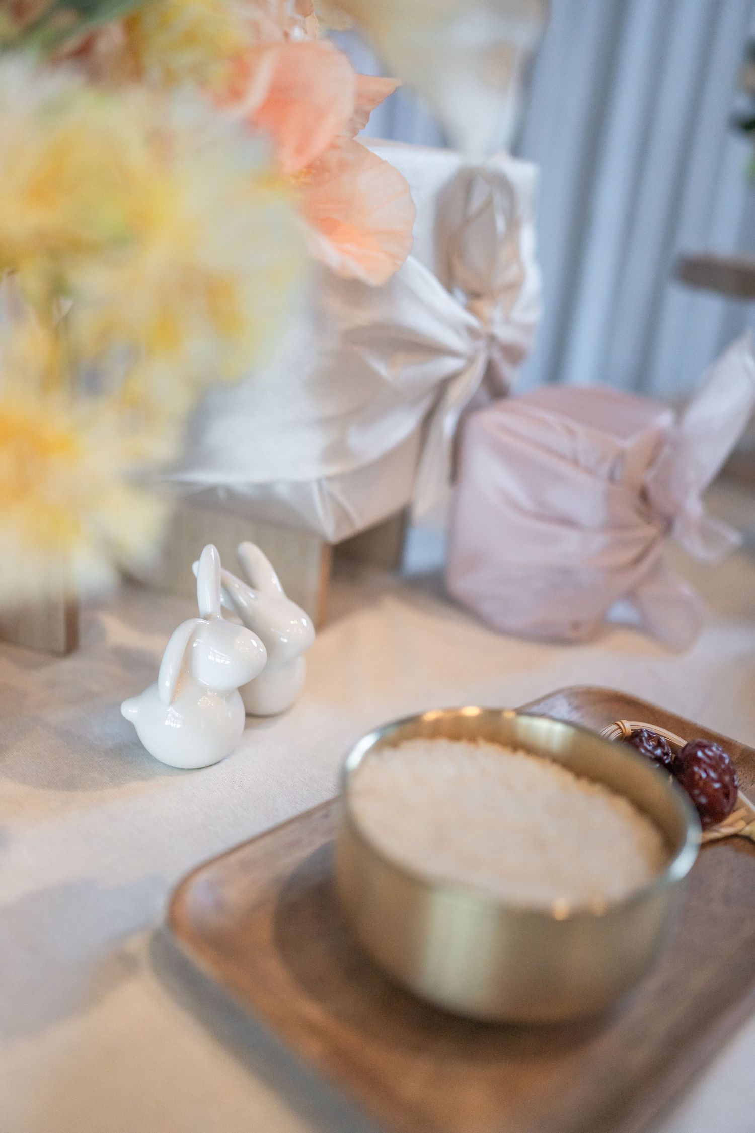 White ceramic teapot sets a cozy dohl scene with soft blurred background and warm lighting effects. Alexandria photographer