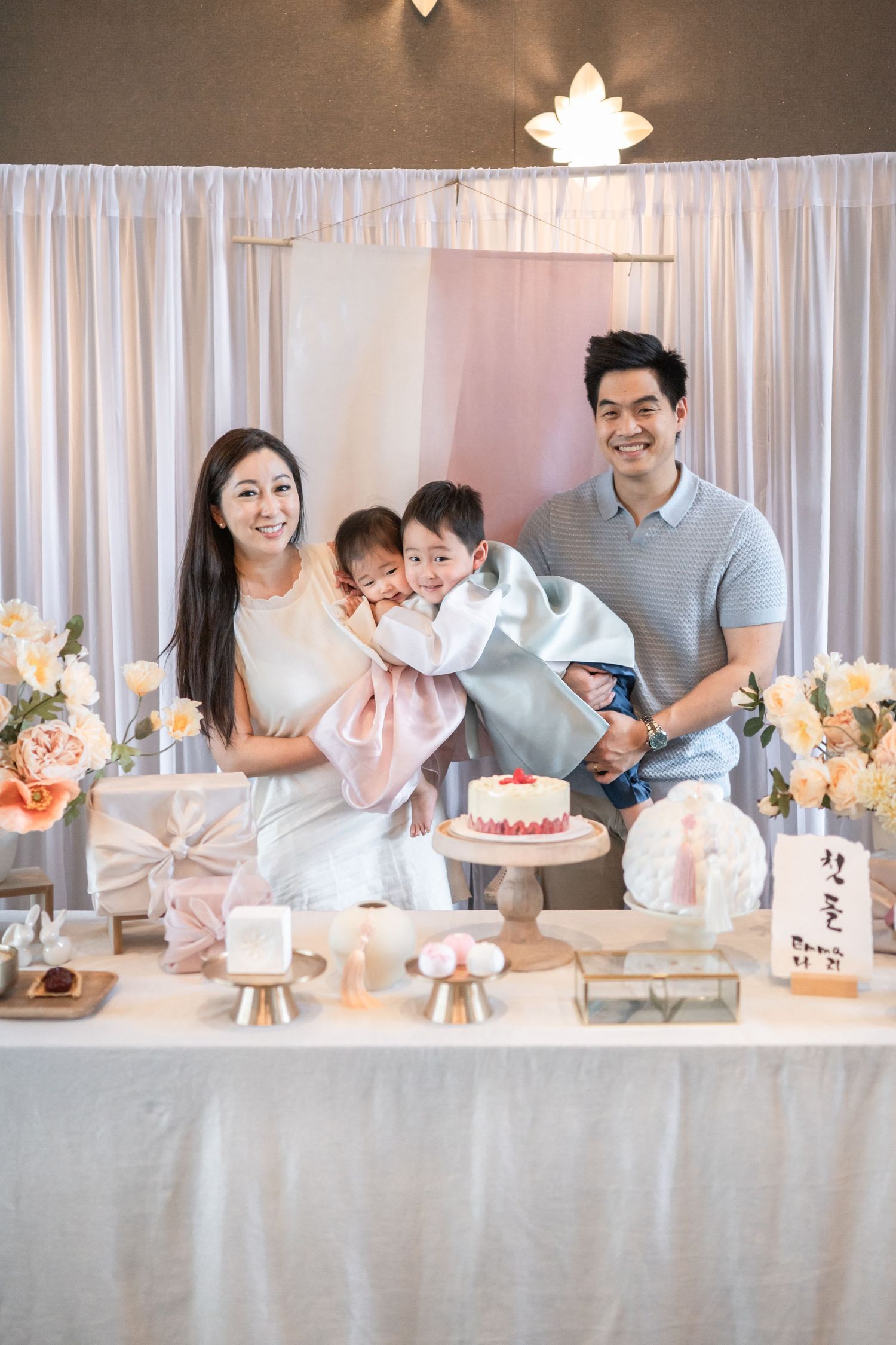 An elegant pink and white themed dessert table setup with cake and decorative elements at a special celebration. Dohl Northern Virginia