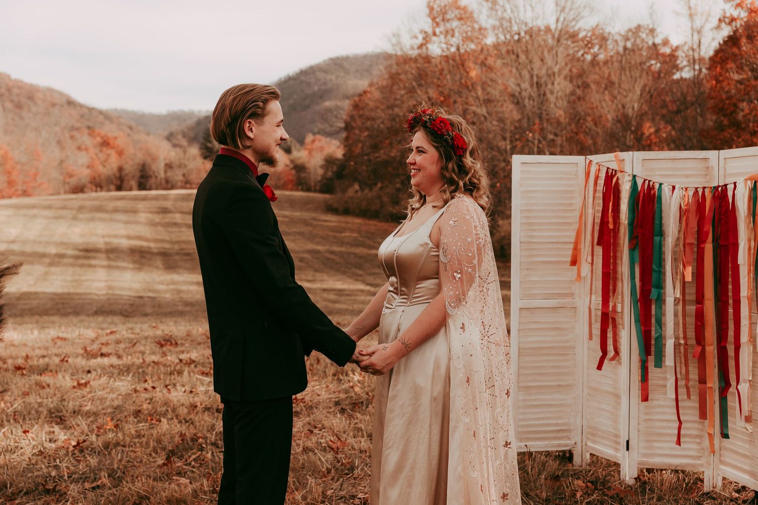 Couple holds hands while saying wedding vows, the beautiful Blue Ridge Mountains in the background. Lexington, Virginia.