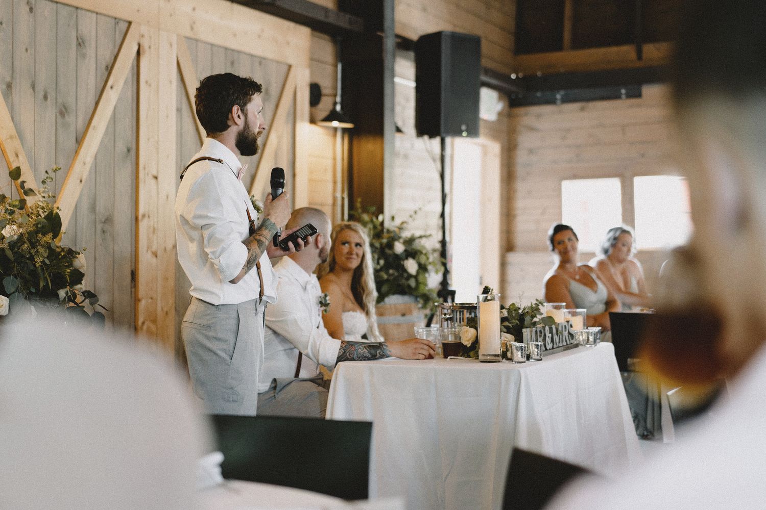 Best man speech at rustic Seattle reception, cinematic documentary photography capturing authentic guest reactions