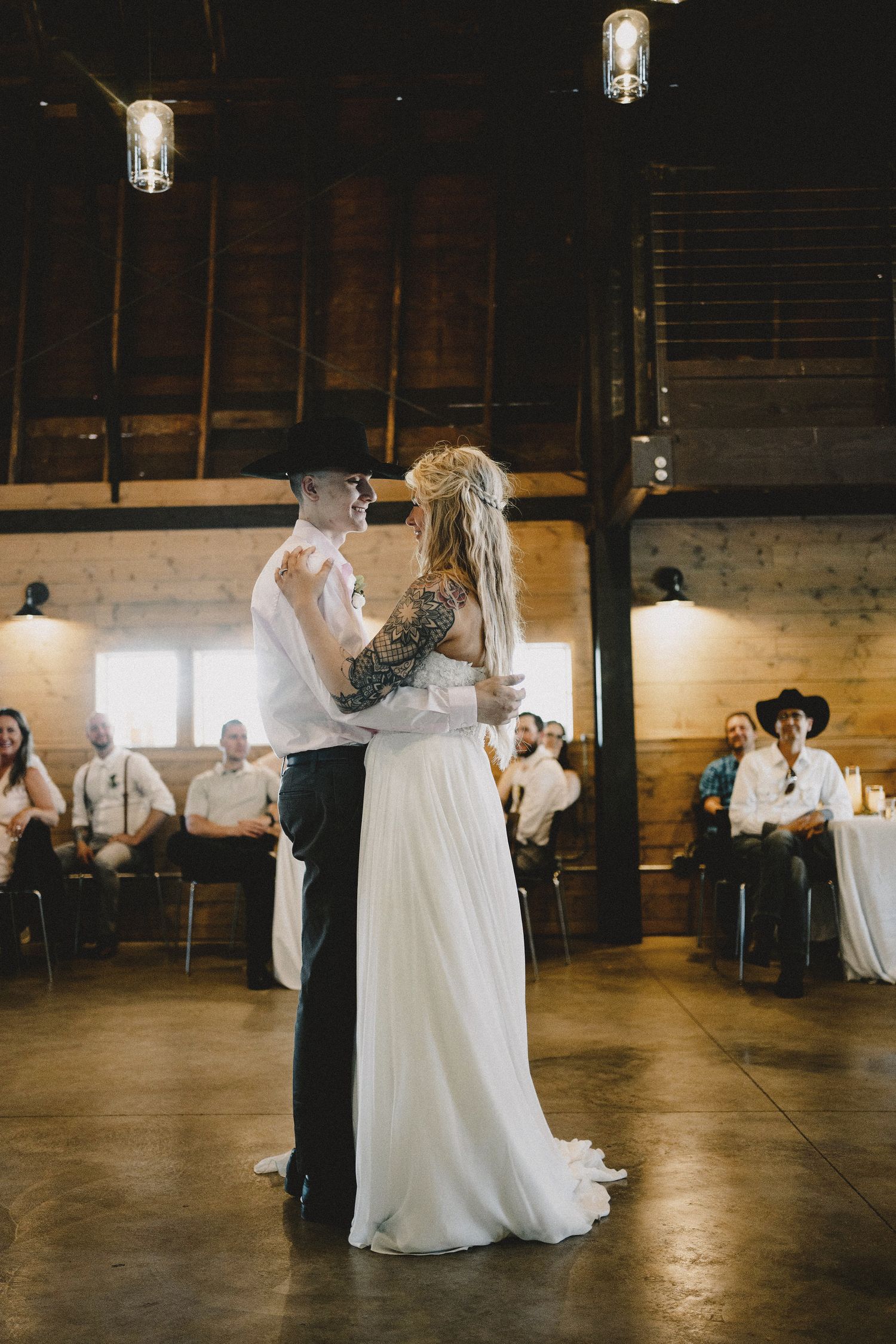 Intimate bride and brother dance moment at Seattle wedding reception, cinematic portrait with golden light and emotional connection