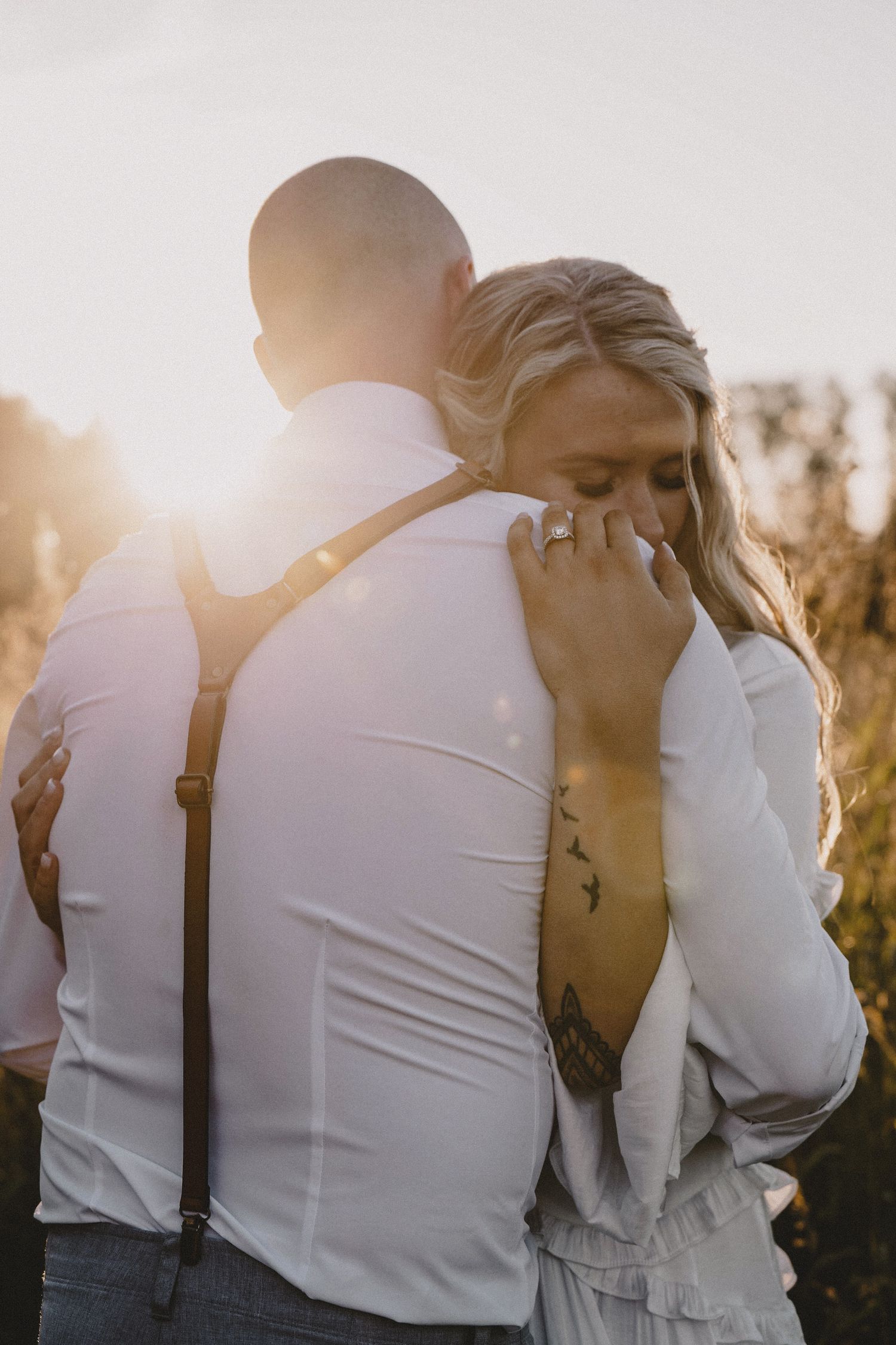 Sunset backlit couple portrait of bride and groom with golden light halo, cinematic wedding photography with romantic editorial styling
