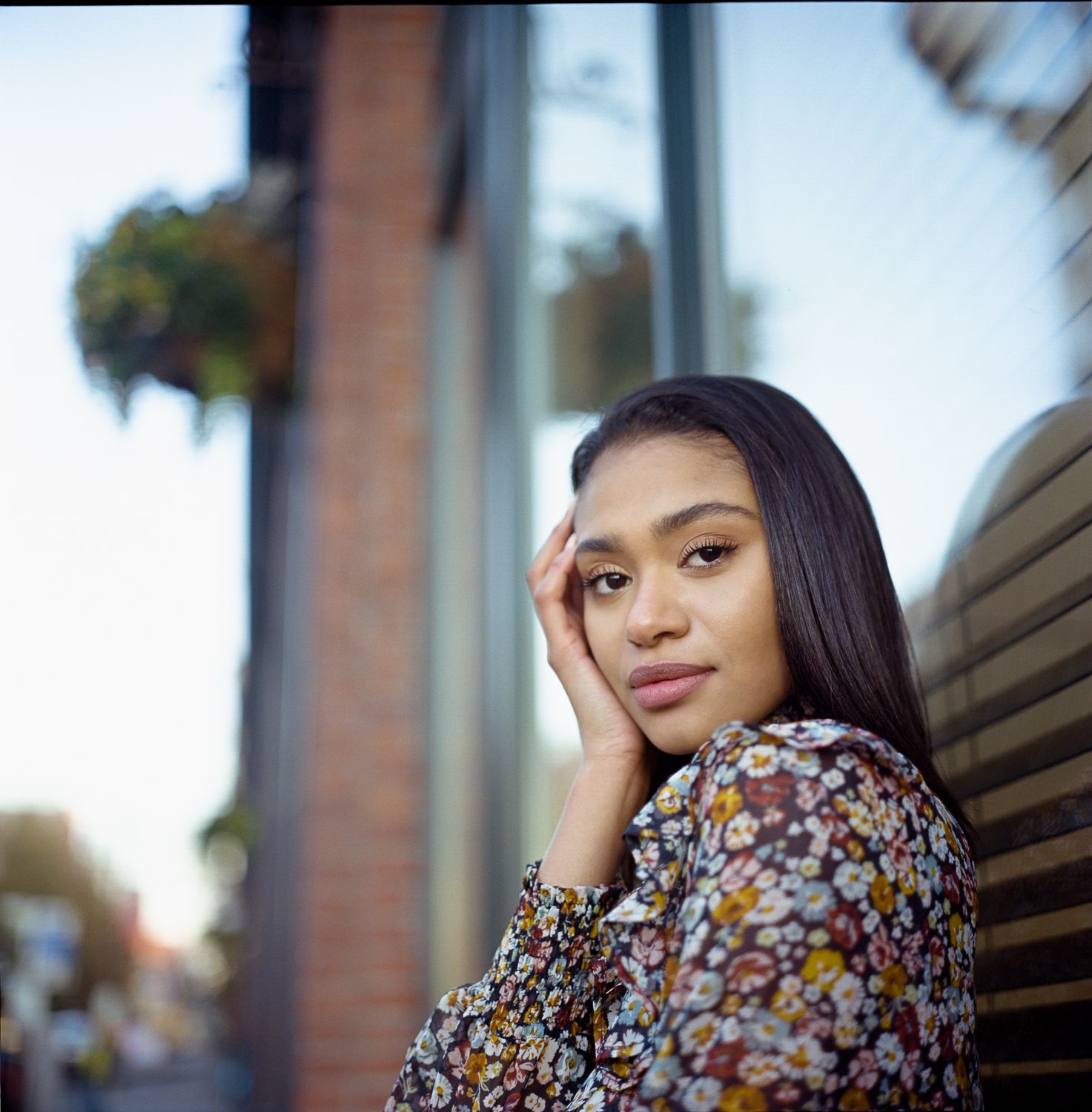 Golden hour portrait with urban background, Seattle medium format film photography with warm tones and editorial styling