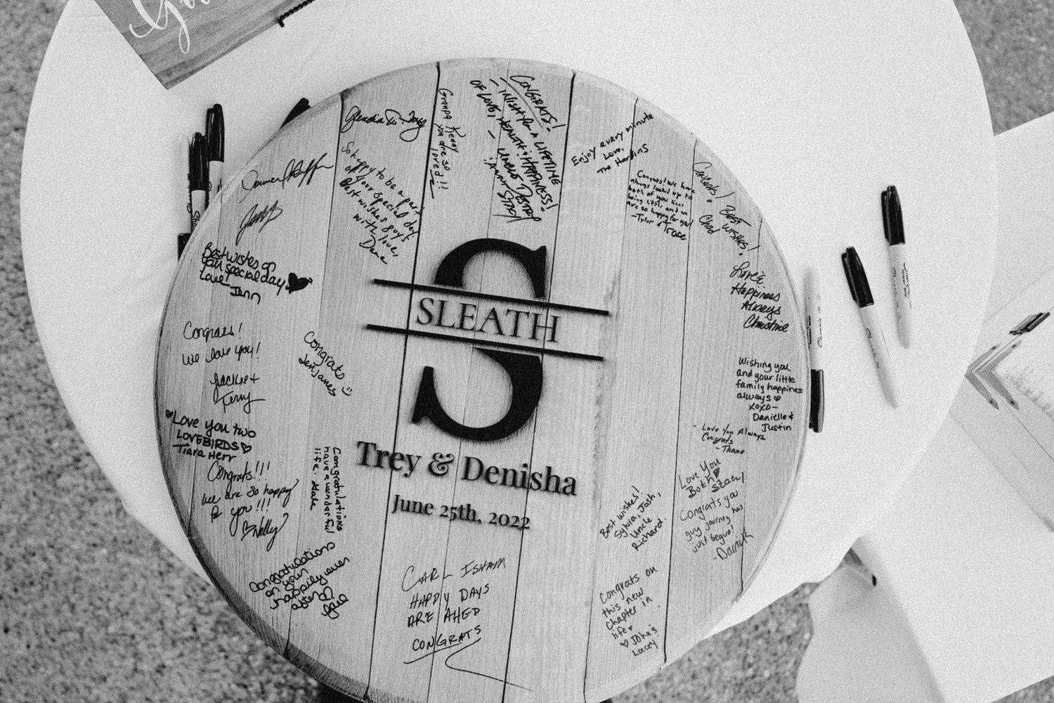 Black and white wedding wooden guest book detail with monogram, cinematic styling at Seattle destination wedding
