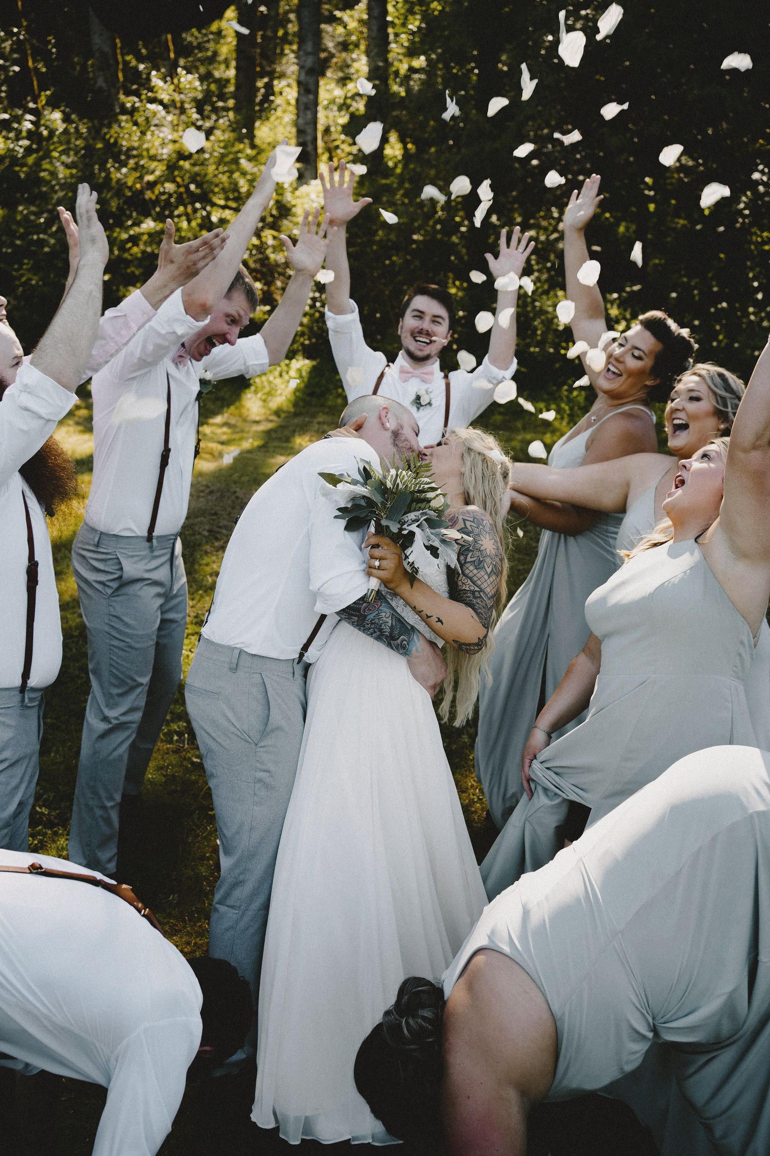 Wedding party moment surrounding the bride and groom cheering, cinematic documentary wedding photography capturing authentic celebration