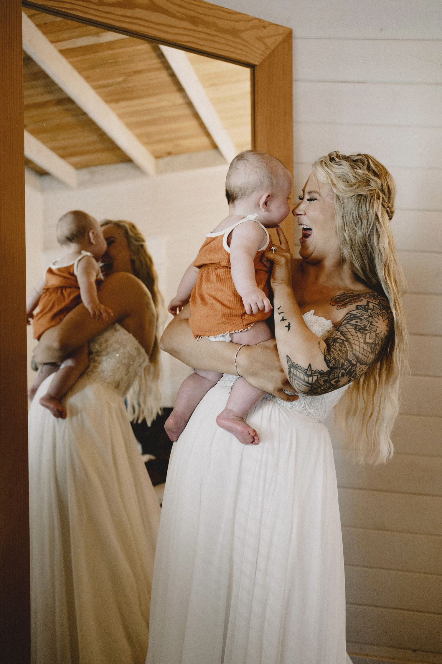 Emotional bride getting ready moment with her child in golden light, cinematic Seattle wedding photography with editorial styling