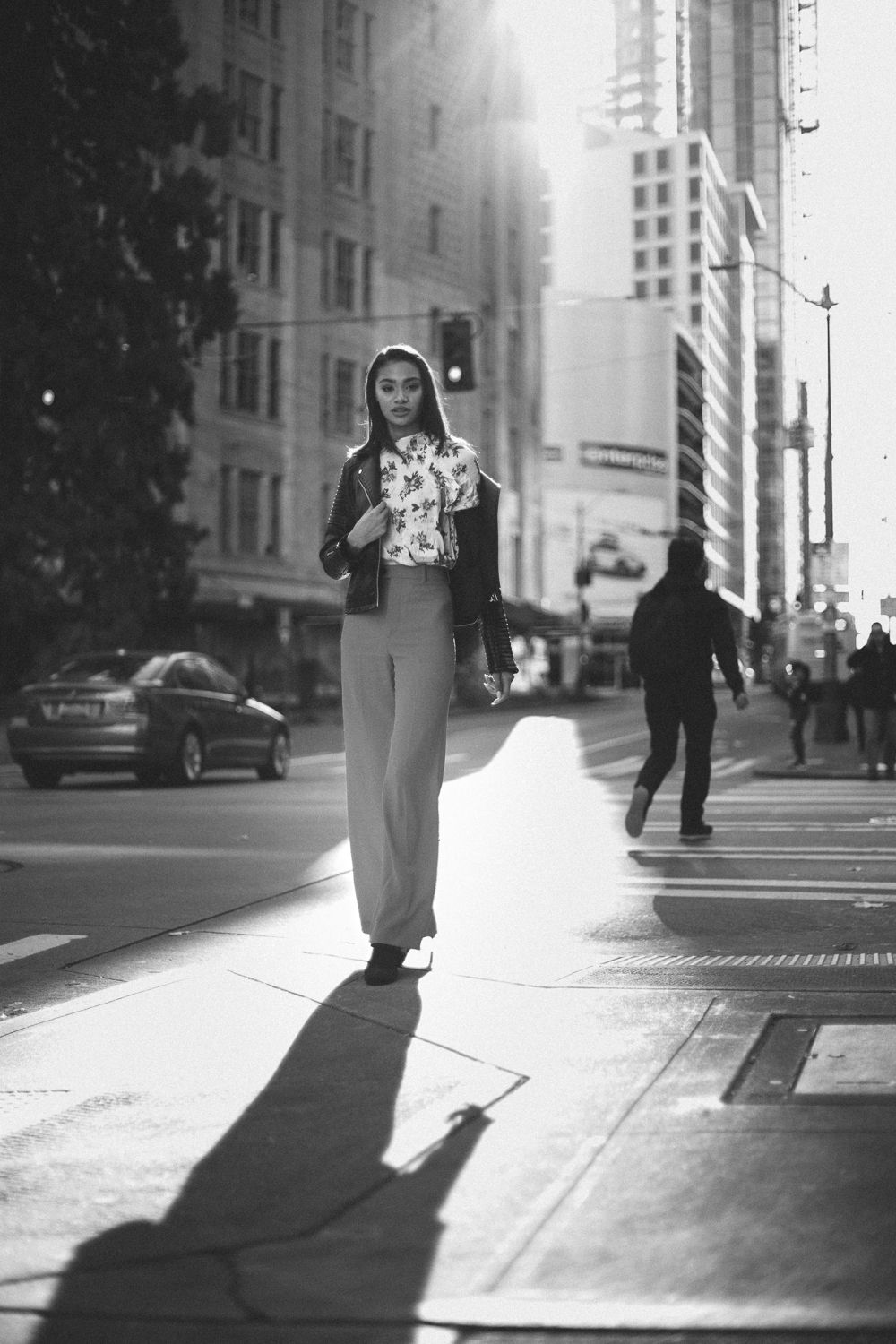 Urban Seattle street portrait with dramatic sunlight and shadow, black and white 35mm film photography with editorial styling