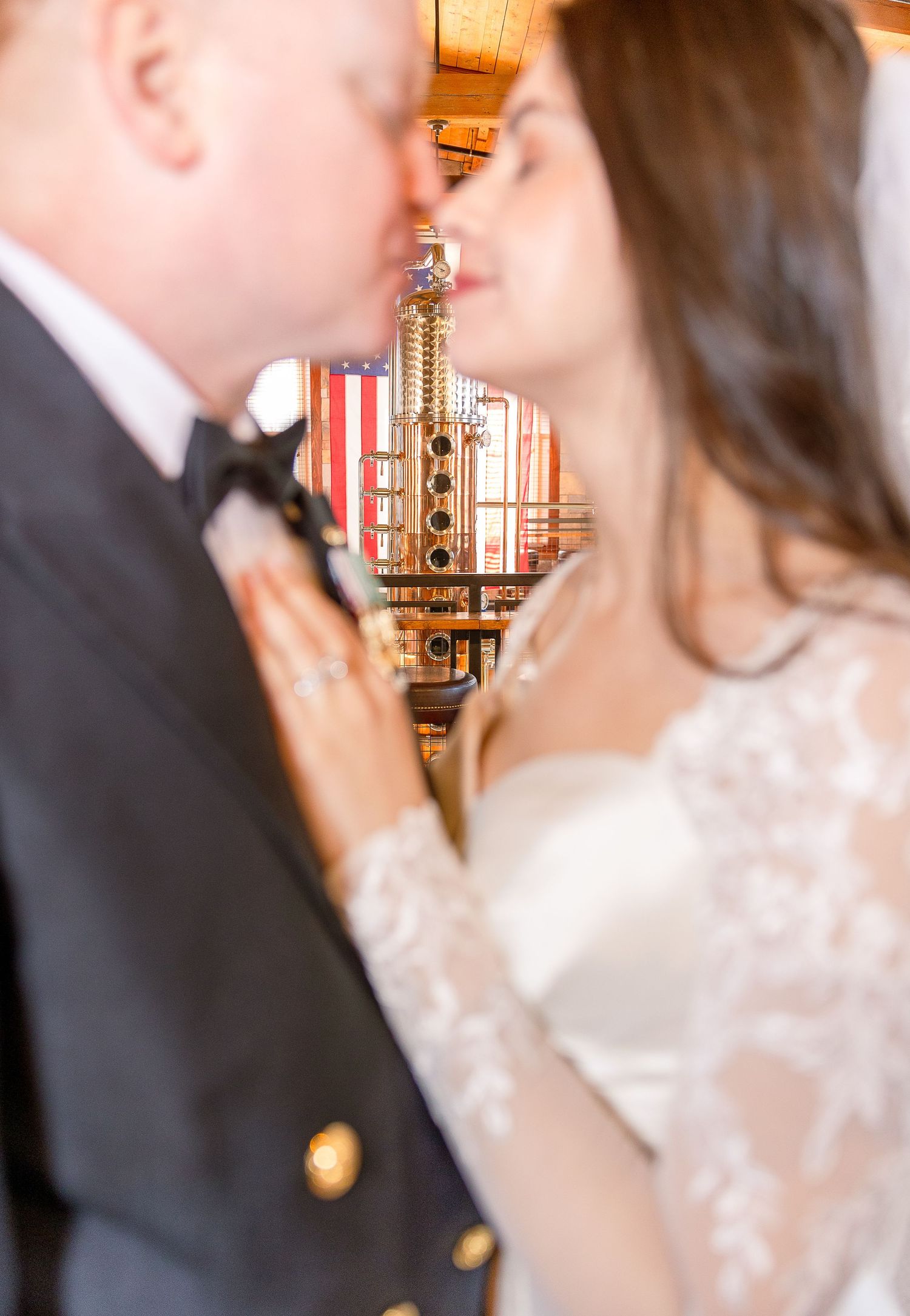 A tender moment captured during a wedding ceremony with bokeh lights and romantic atmosphere in the background.