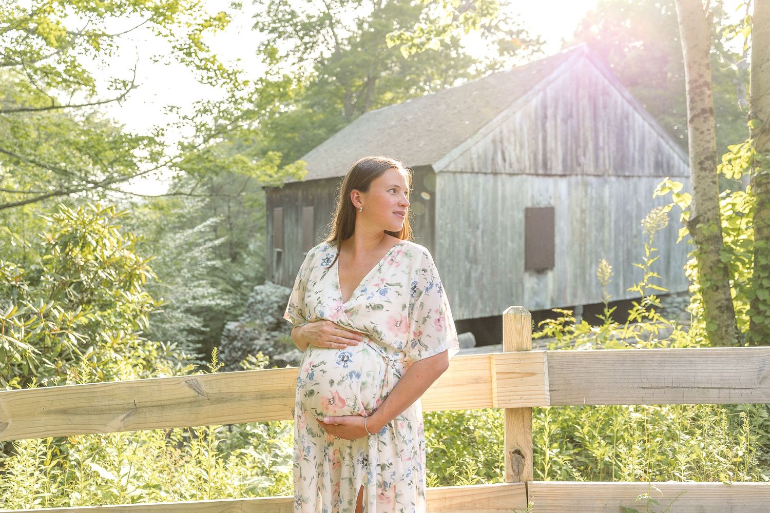 A rustic barn setting with golden sunlight and greenery creating a peaceful countryside scene.