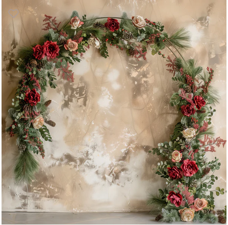 Romantic floral arch with red and pink roses, greenery, and pine branches against a textured beige wall backdrop.
