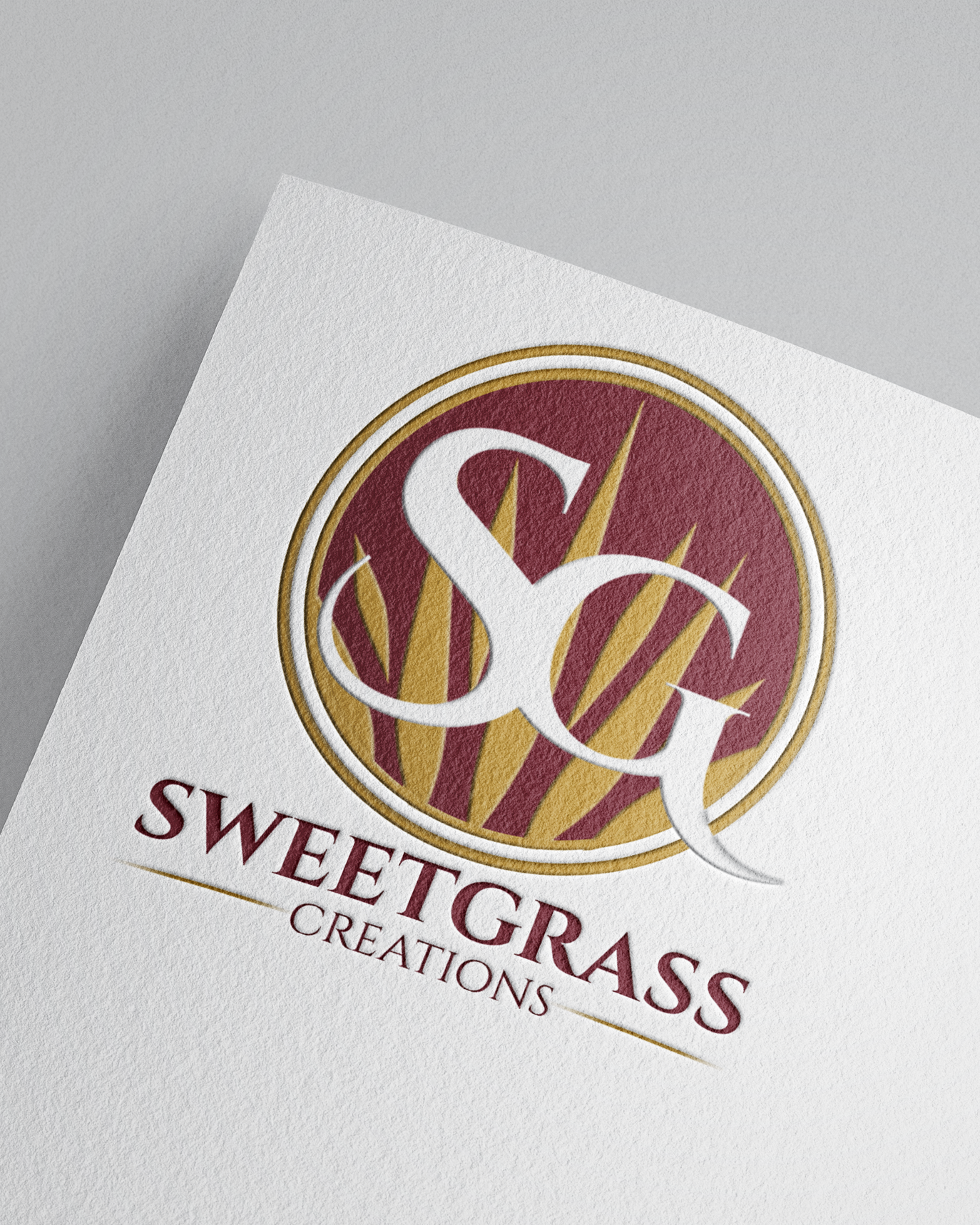 Elegant Sweetgrass Creations logo design with gold and burgundy circular emblem on textured paper. Portrava Creative Studios