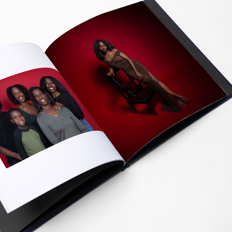 Photo album spreads with portraits against deep red backgrounds.