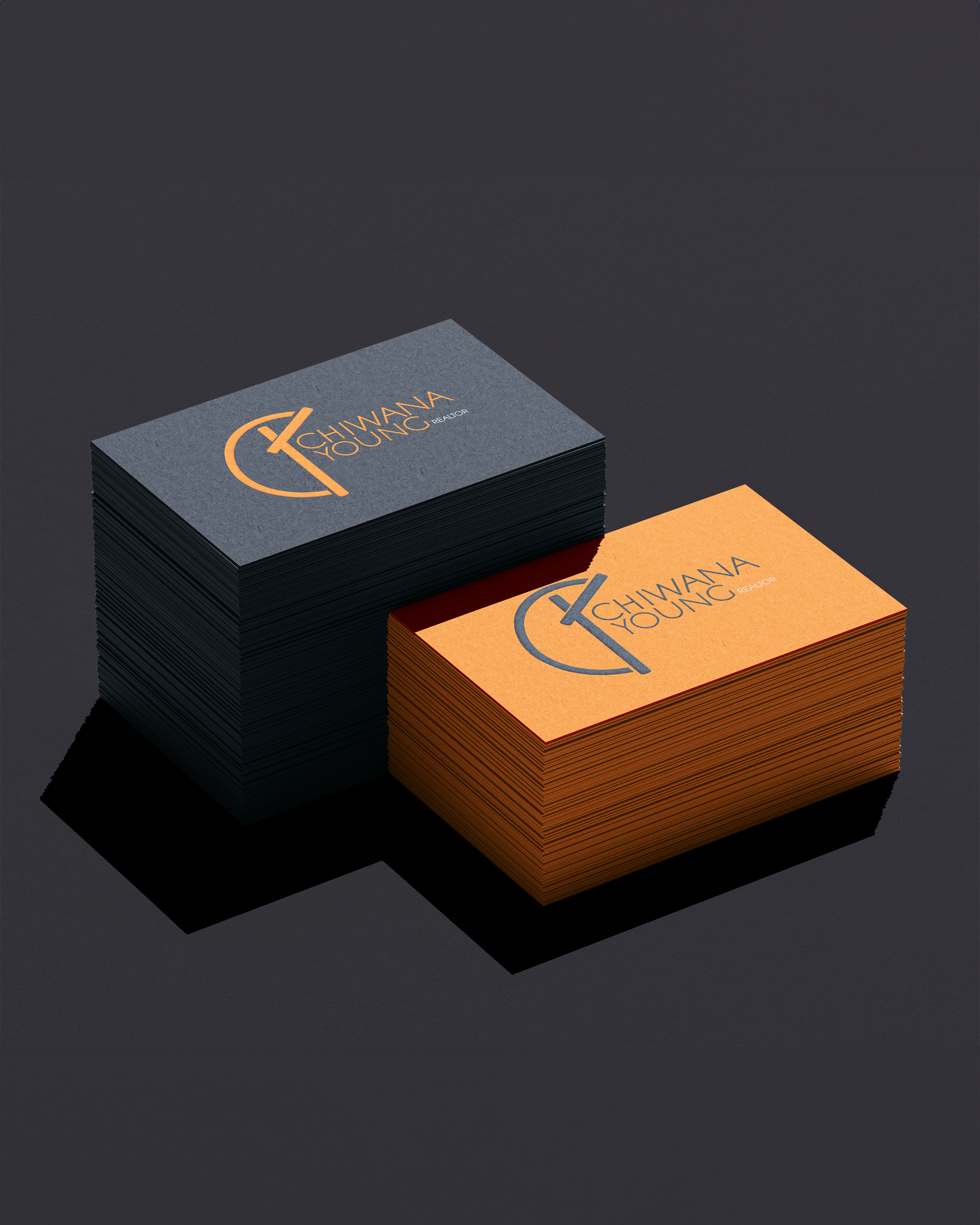 Two stacks of business cards in black and orange with Dynamax logo design. Portrava Creative Studios