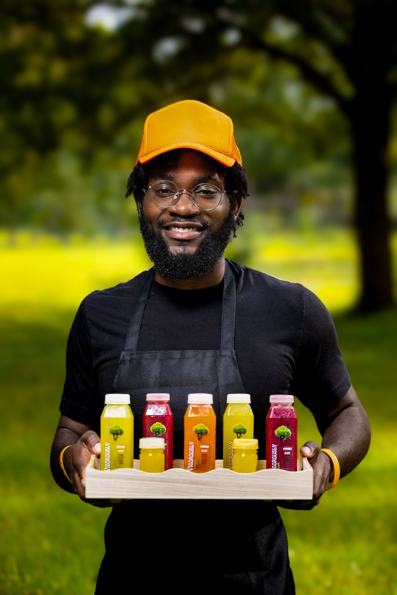 Collection of colorful fresh juice bottles arranged on wooden tray in outdoor setting. Portrava Creative Studios