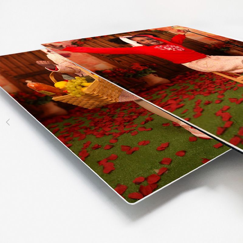 Multiple photo prints arranged in a cascading perspective showing vibrant red and green colors.