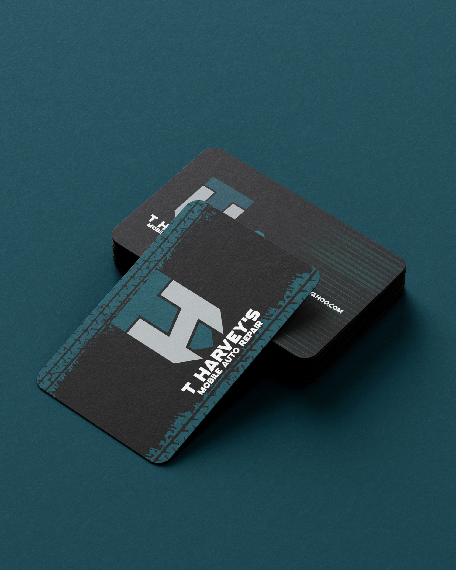 Minimalist black business cards with H monogram design on teal background. Portrava Creative Studios