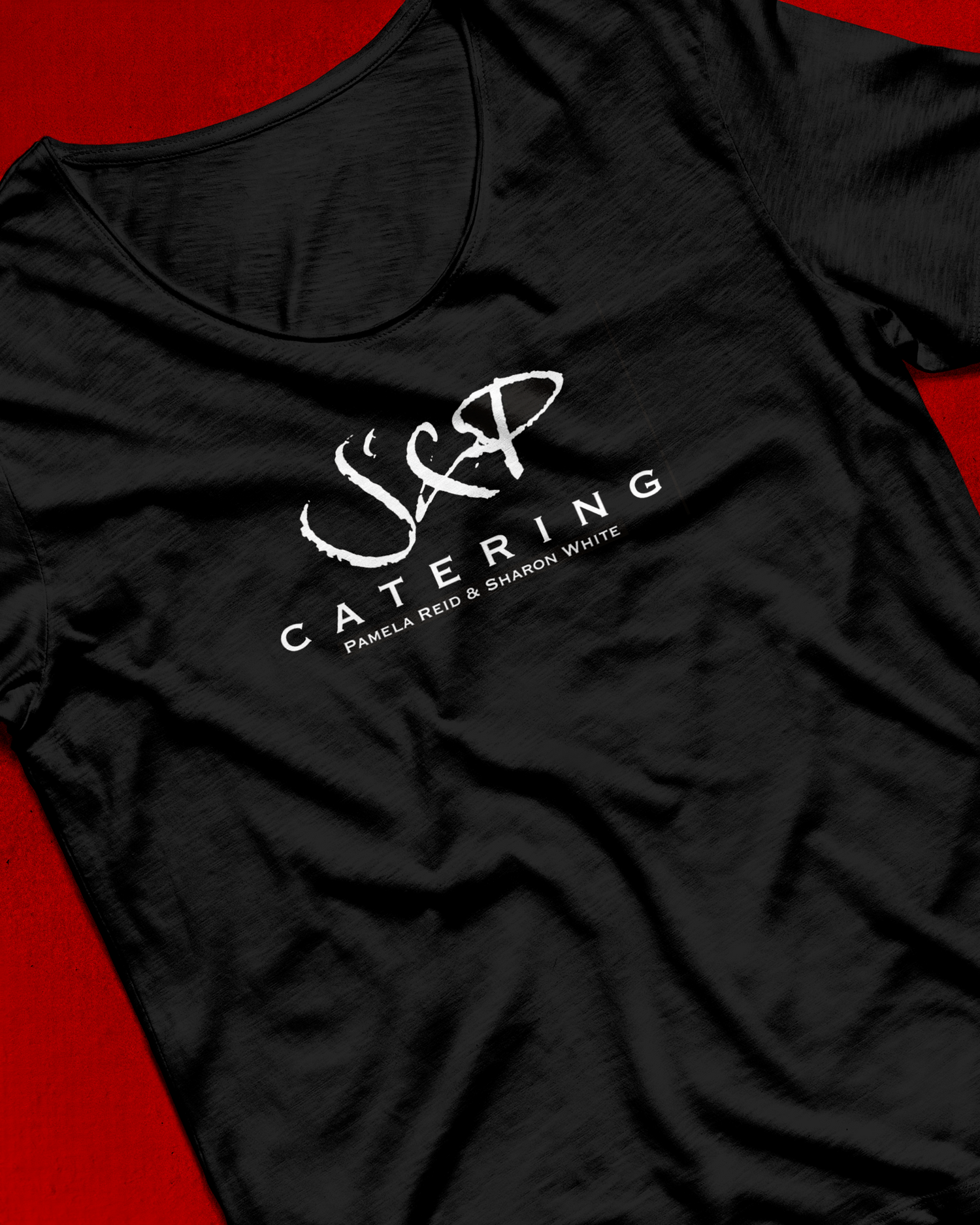 Black t-shirt with white J&P Catering logo design on red background. Portrava Creative Studios