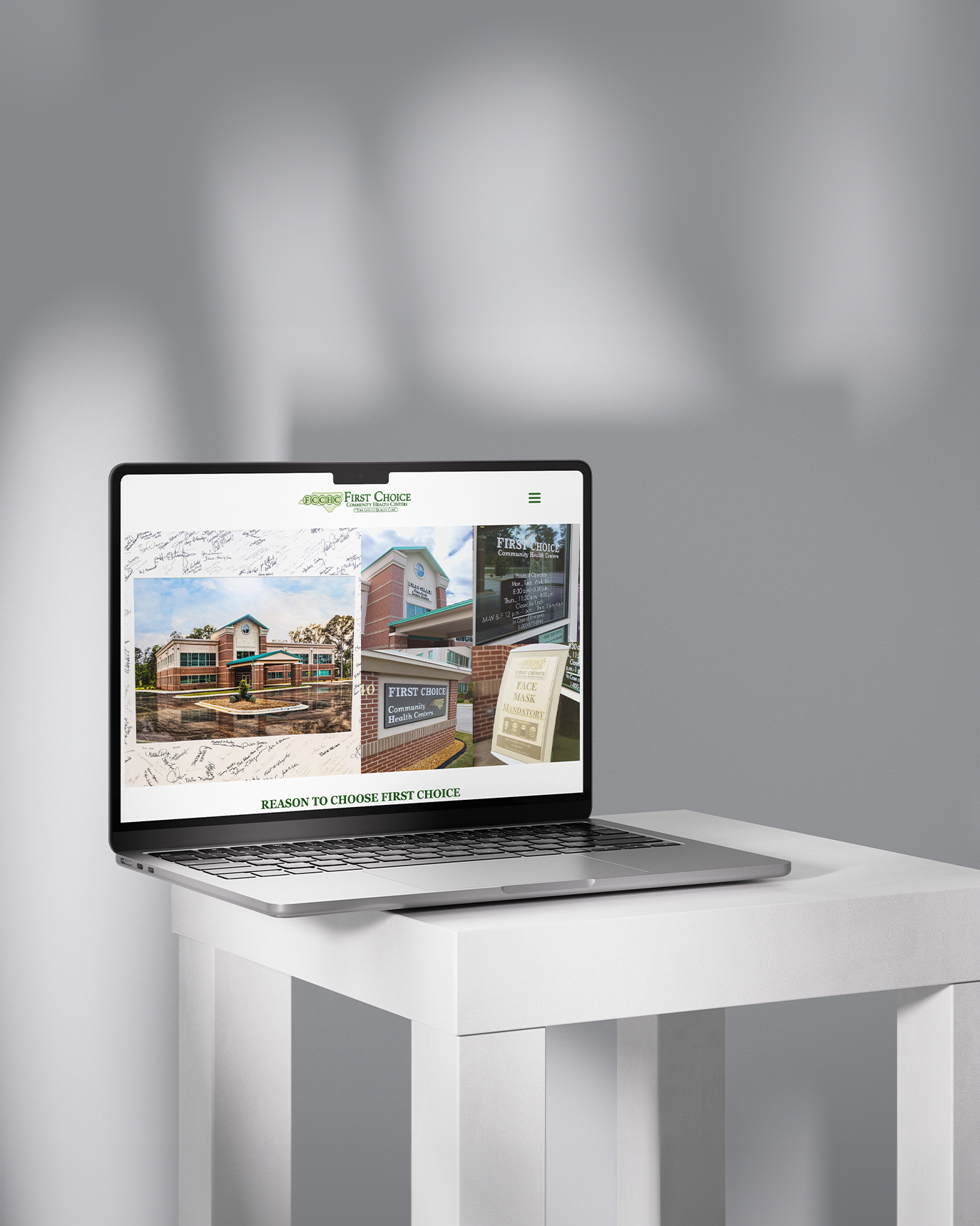Modern laptop showing real estate development website with residential buildings on white desk. Portrava Creative Studios