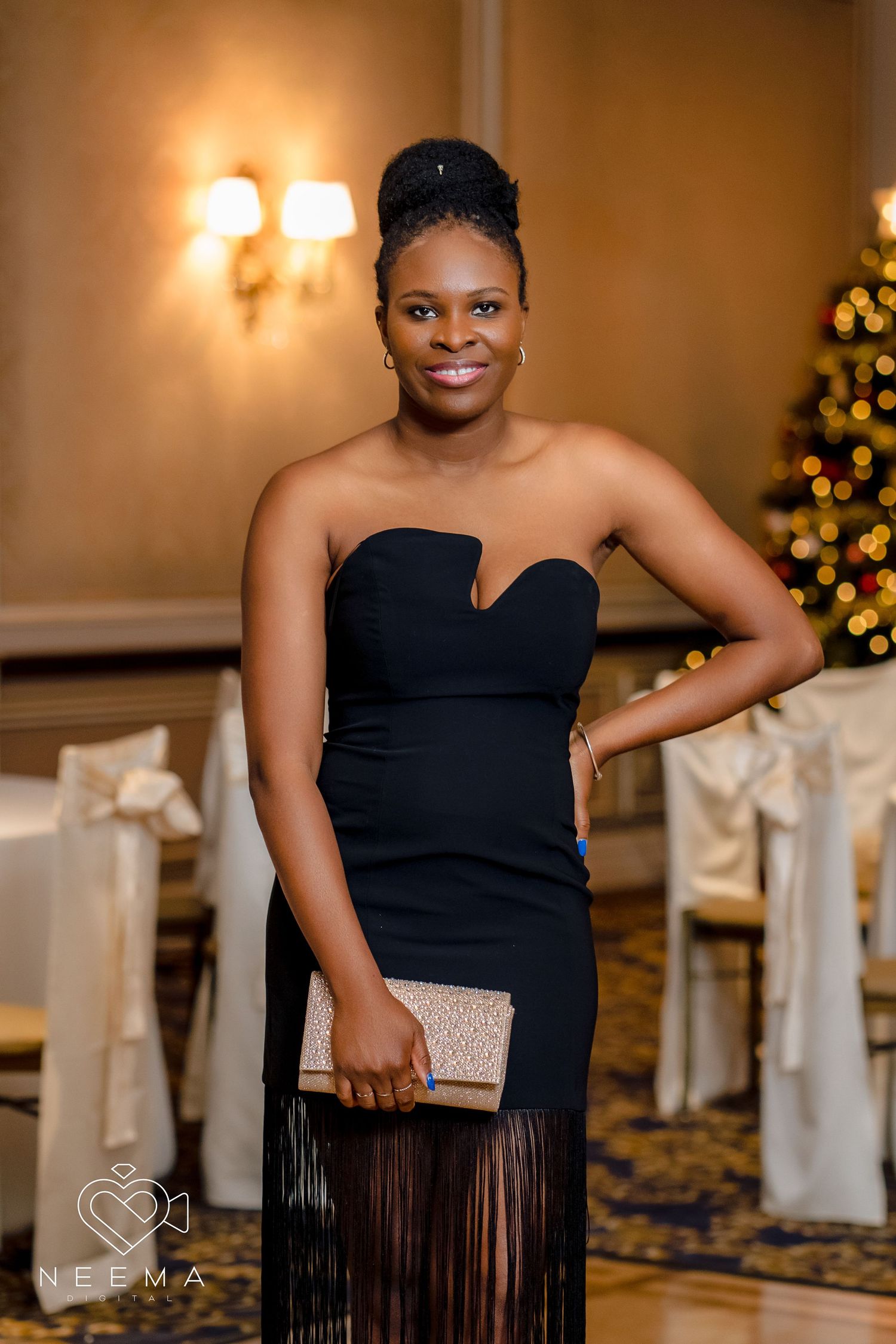 Elegant black strapless dress with fringe detail photographed at a formal event.