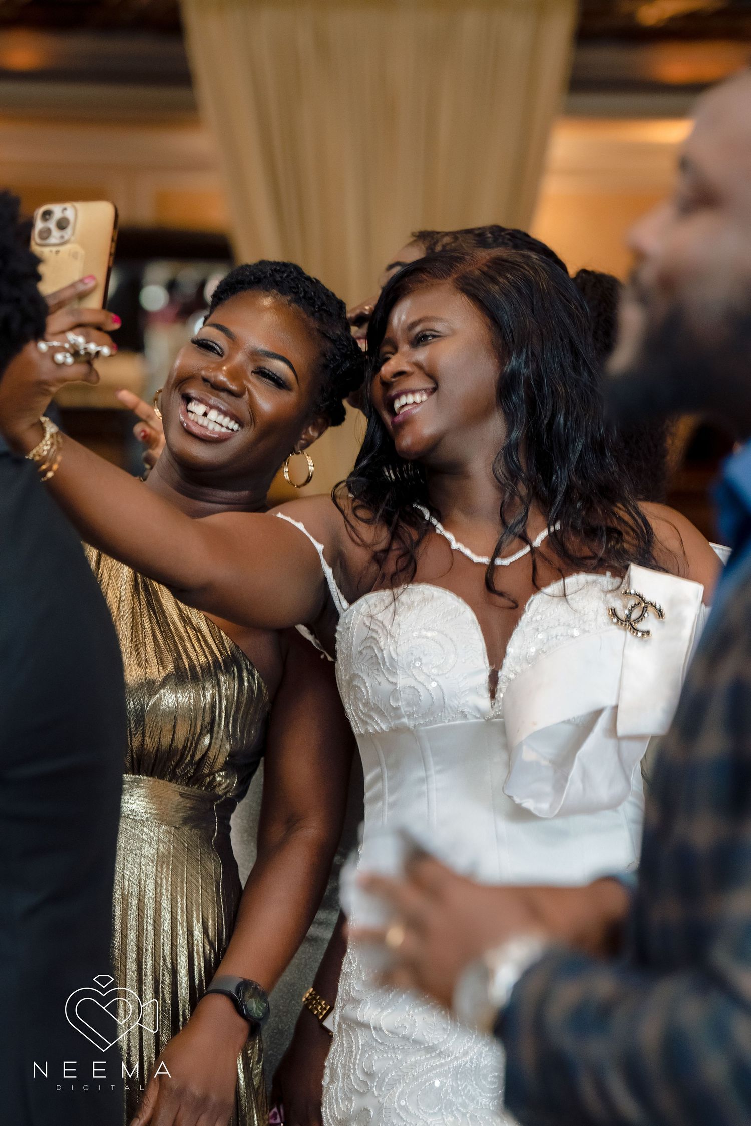 Wedding celebration moment with guests taking selfies during a festive reception.