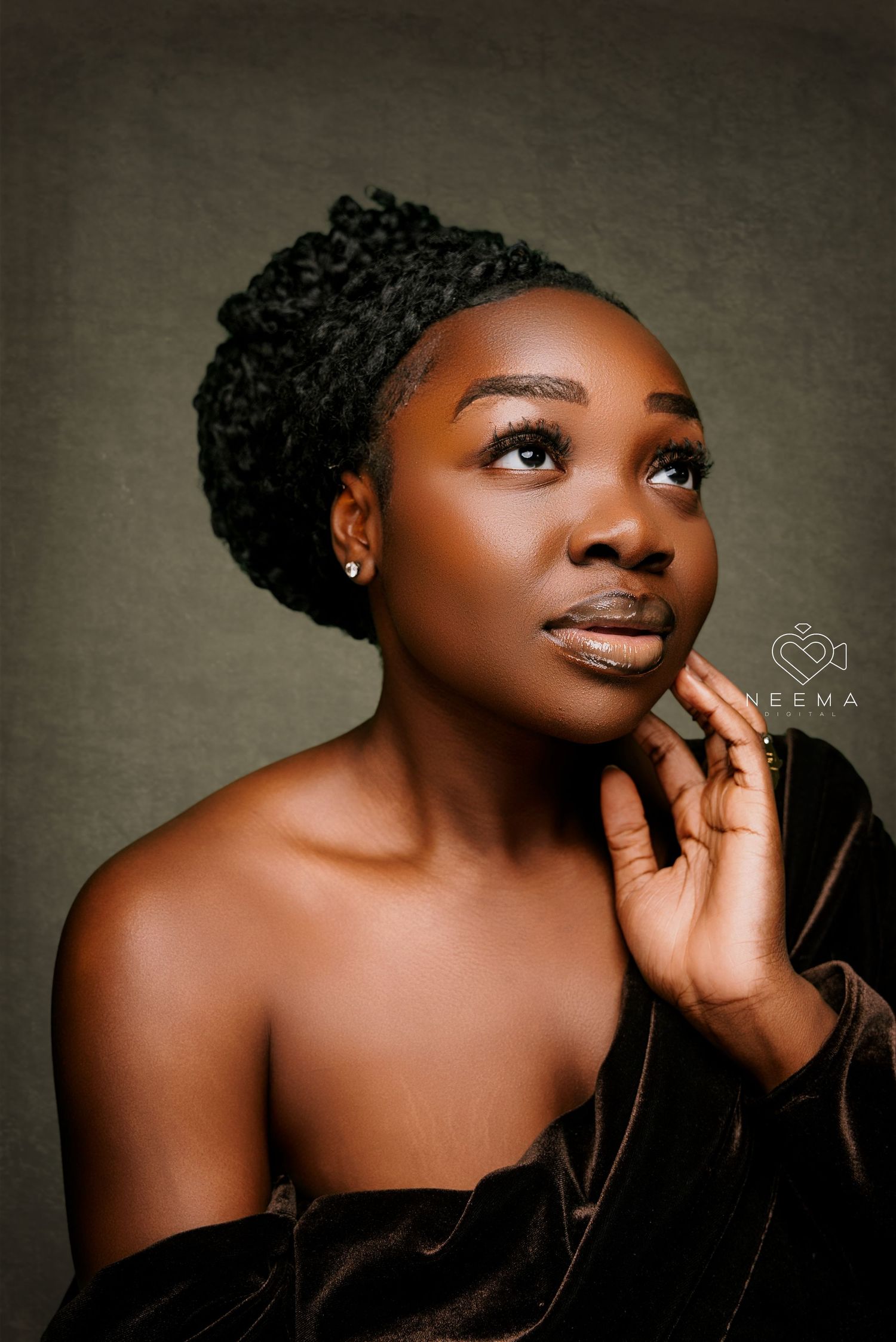 Artistic portrait with dramatic pose and lighting against neutral background.