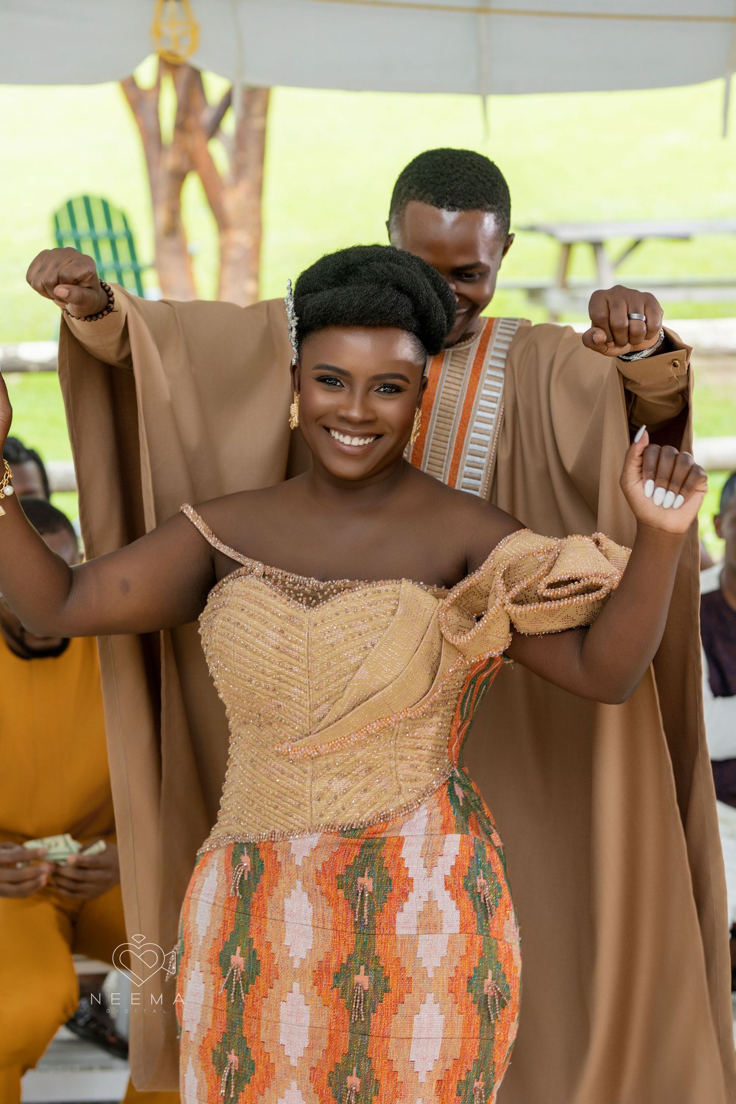 Joyful dancing moment at a wedding celebration featuring traditional African-inspired attire.