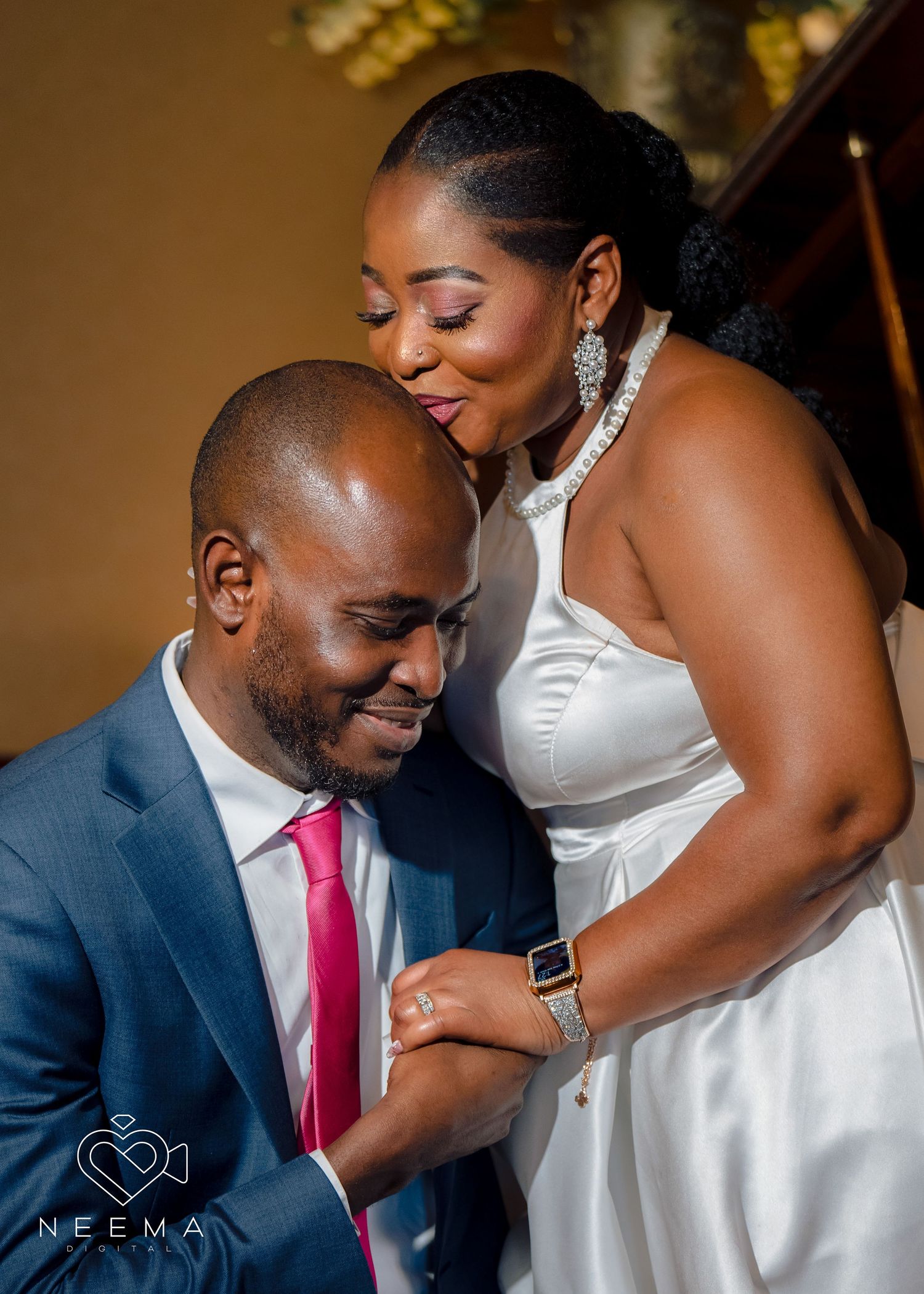 Wedding couple shares intimate moment in elegant formal attire.