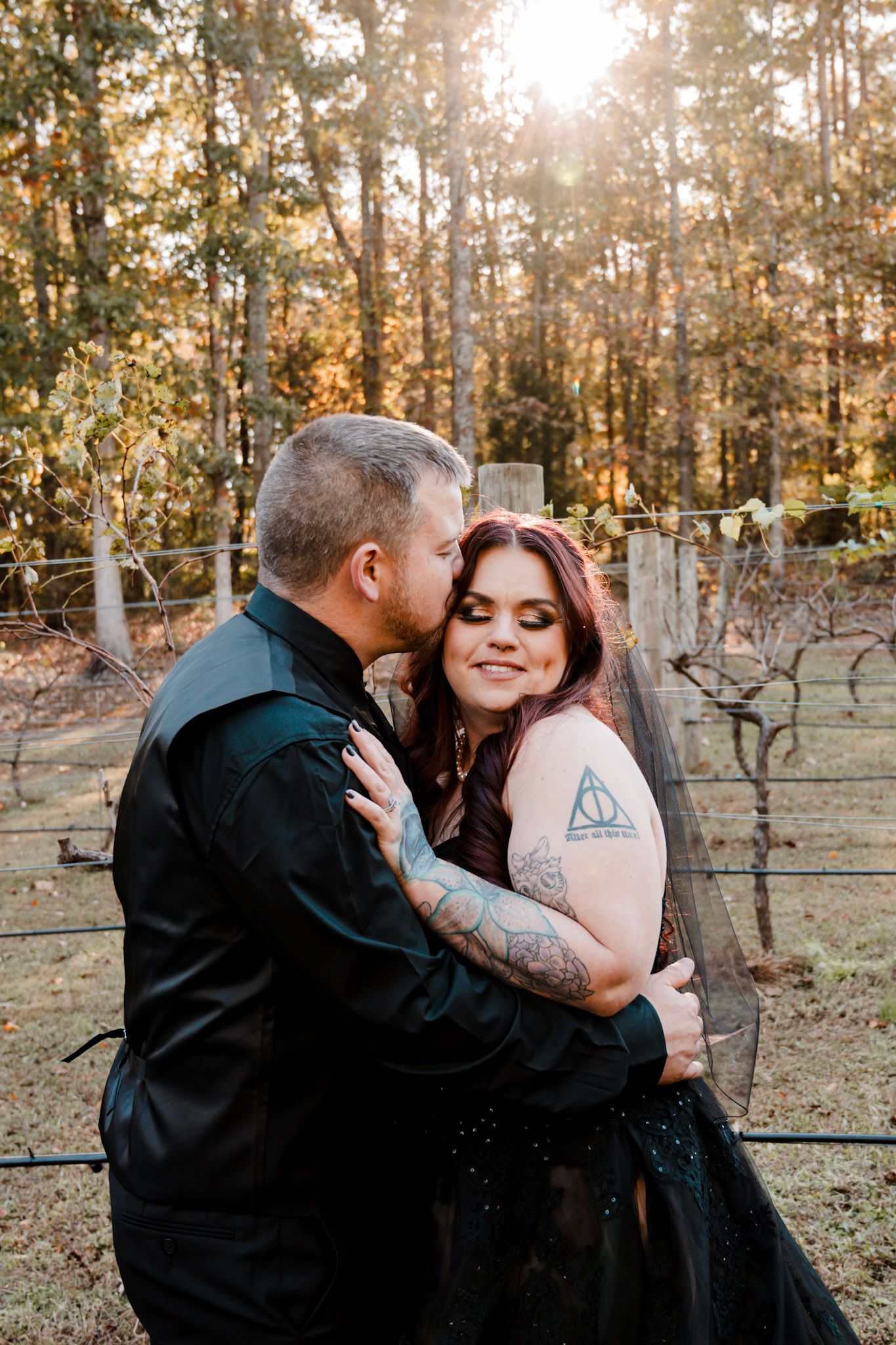 A couple embraces in a romantic outdoor photoshoot at sunset in a vineyard Koury Farms in Auburn, Georgia.